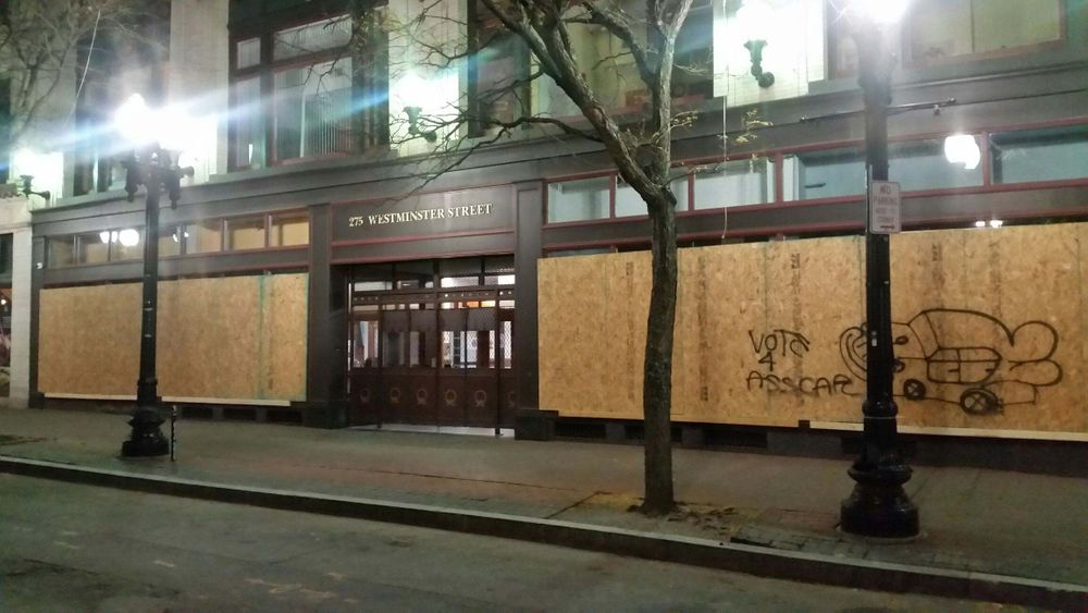 Street-level windows are boarded up in downtown Providence Tuesday night