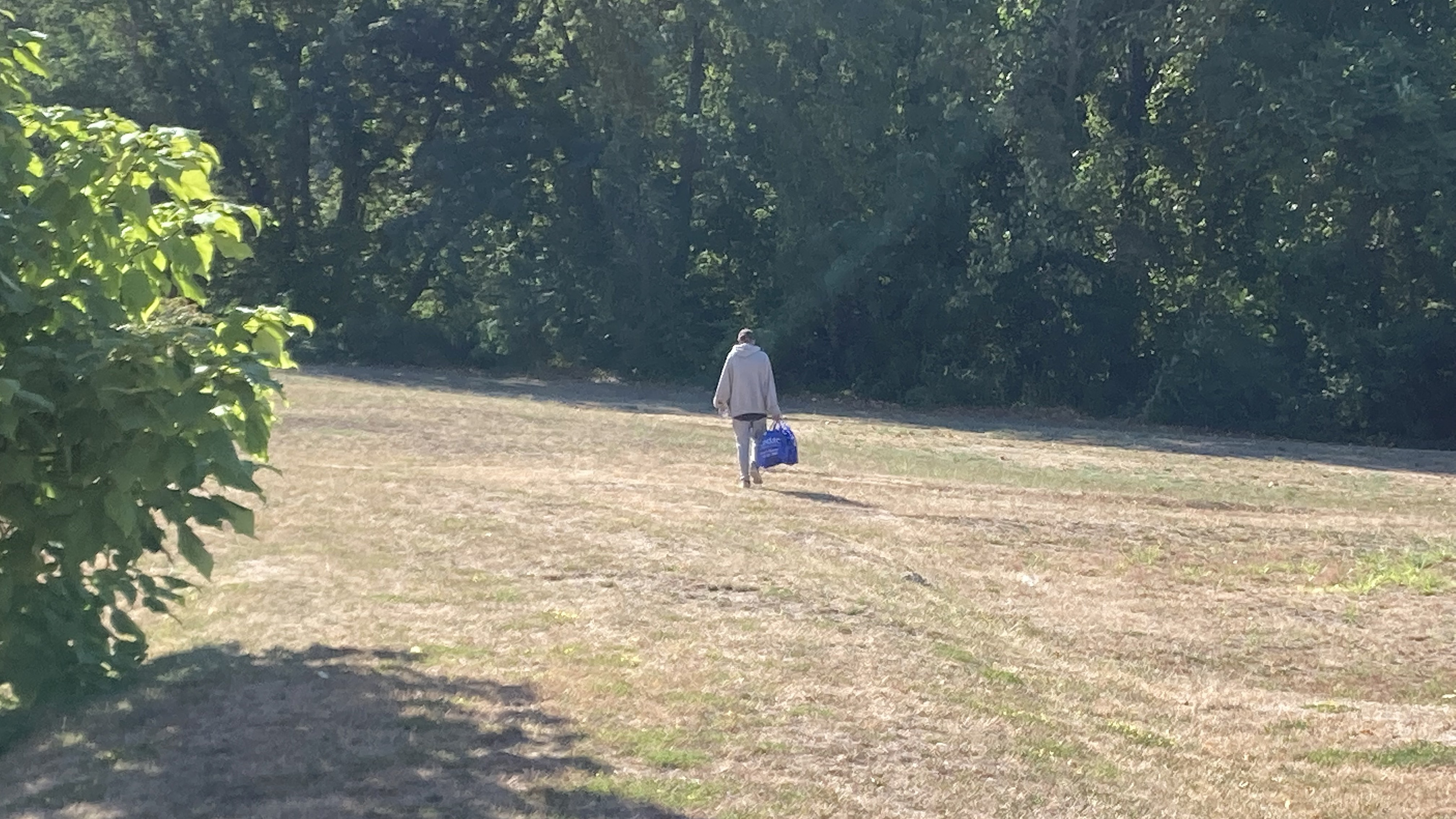 Cory heads back to his tent encampment with a bag containing naloxone and other harm reduction supplies from CODAC's mobile clinic.