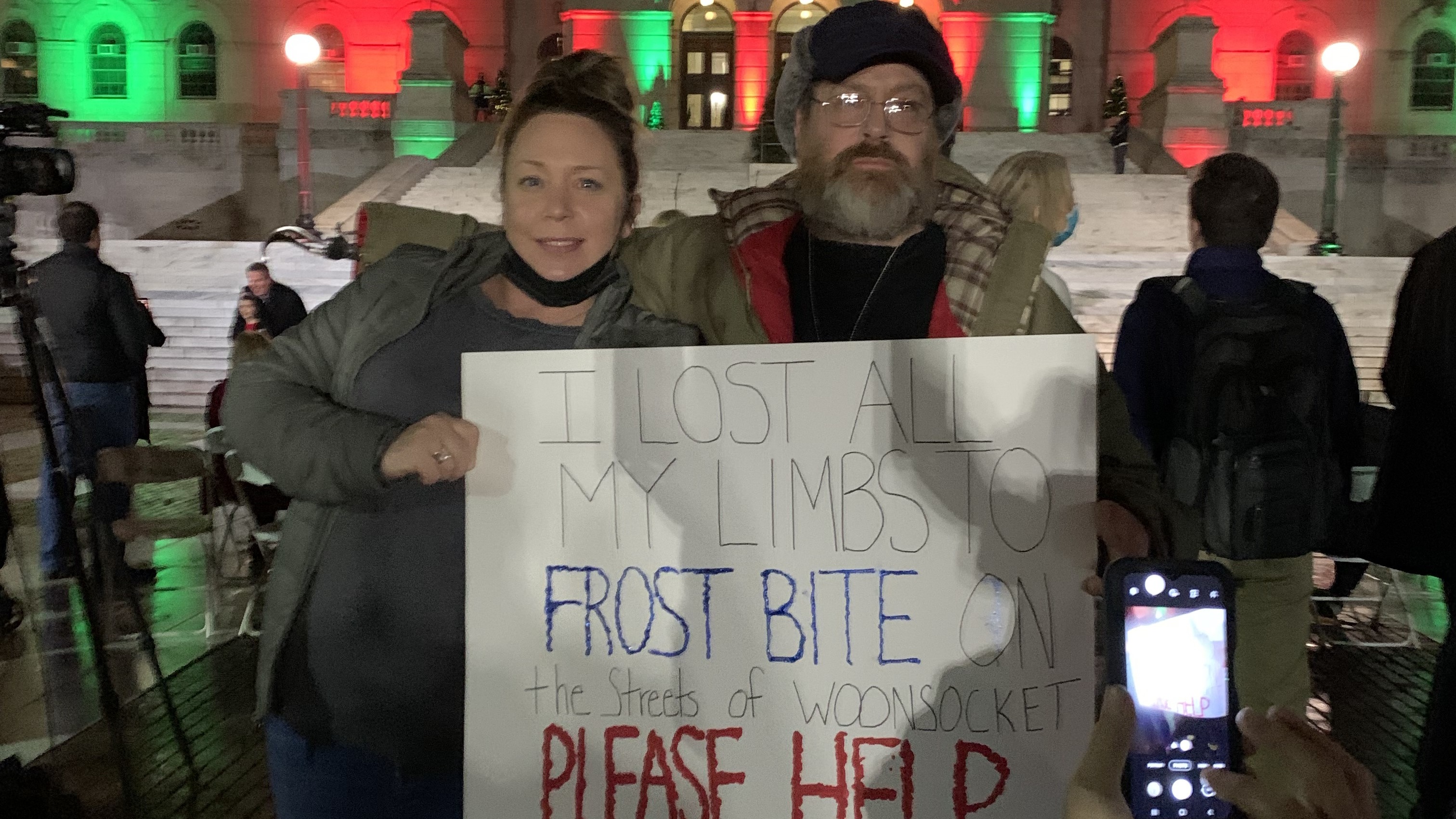 A formerly homeless man, Bill, with Amanda Leigh, then of Thundermist Health Center, at a State House protest in 2021.