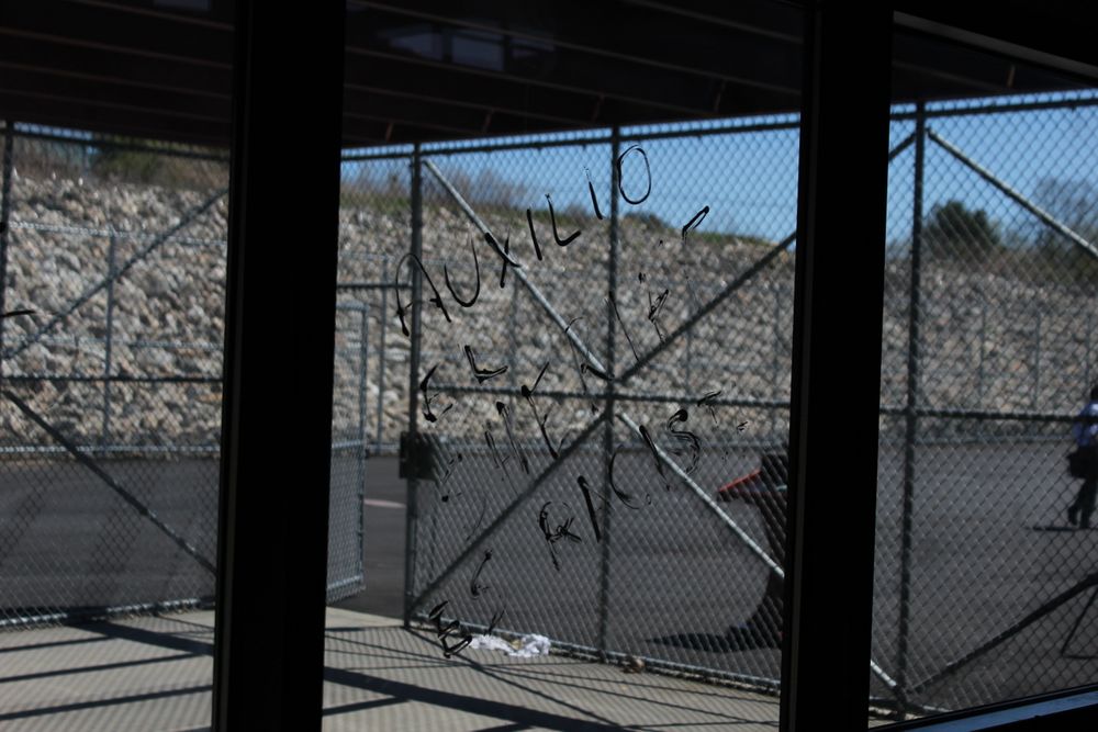 Graffiti scrawled on a window of Bristol County's ICE detention center.