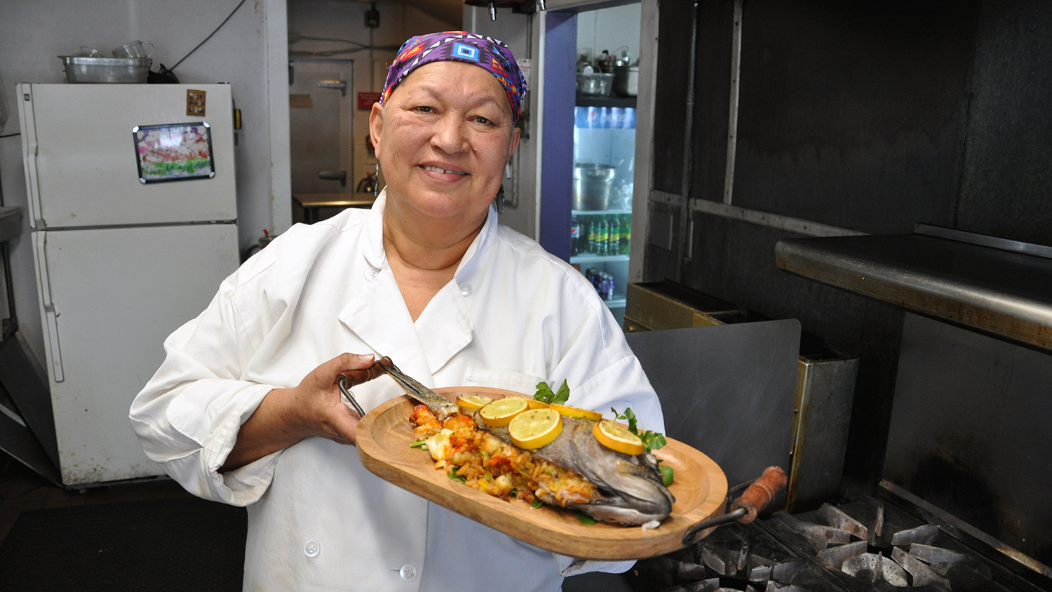 Chef Sherry Pocknett of Sly Fox Den Too in Charlestown displays her black sea bass stuffed with lobster meat.
