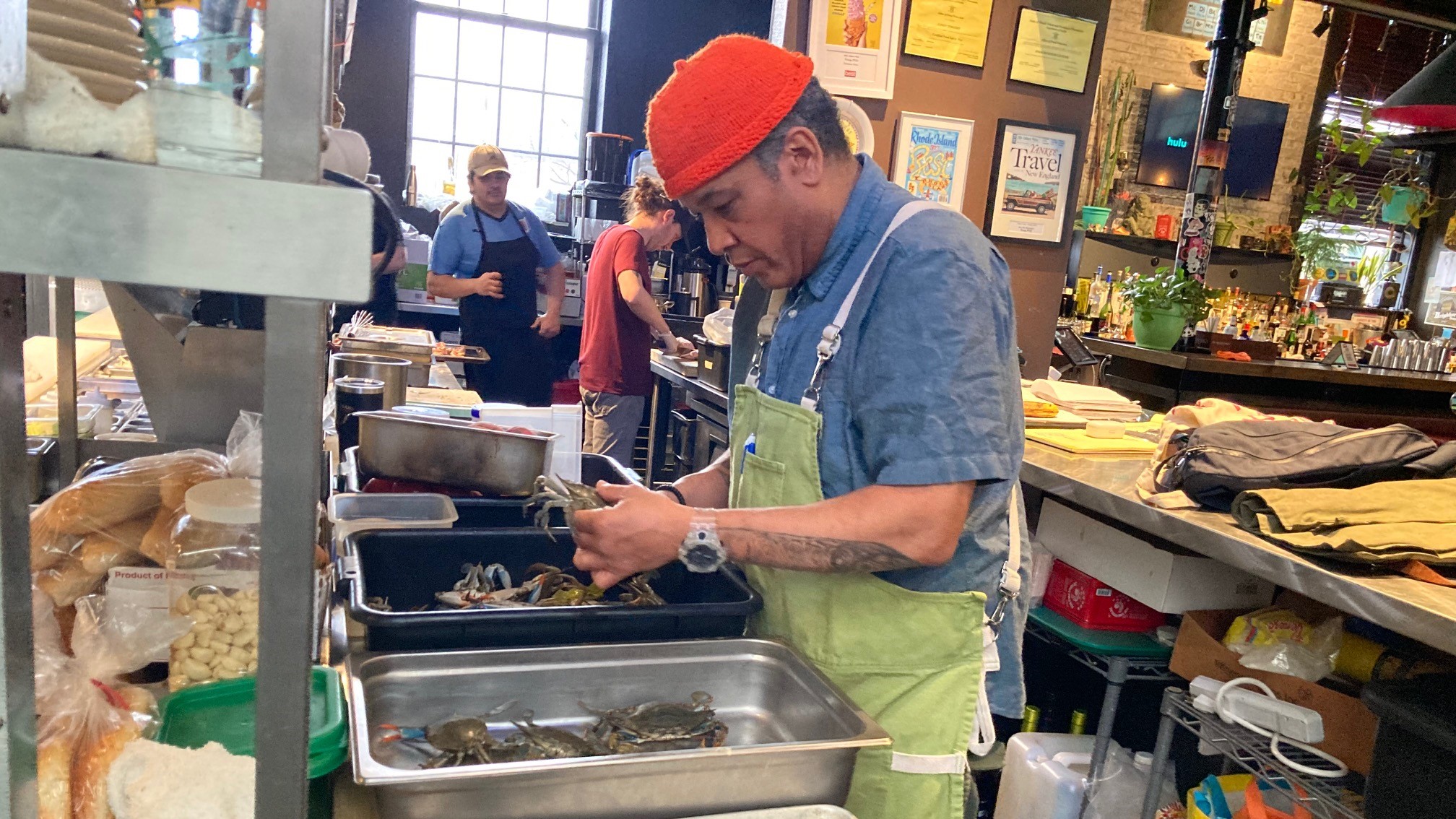 Jason Timothy sorts blue crabs in the kitchen of his restaurant, Troop. 
