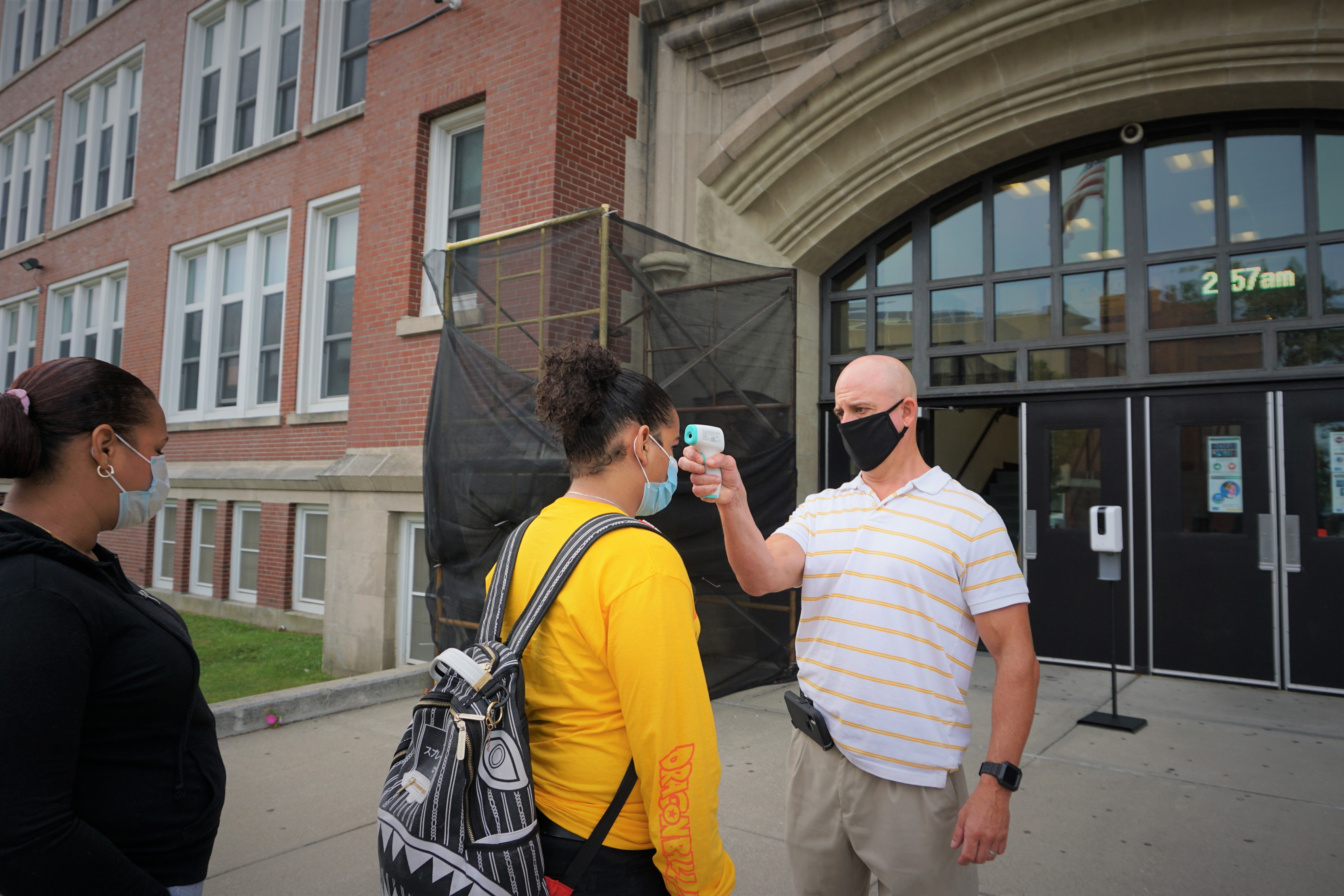 Students get temperature checks before entering Central High School in Providence on the first day of class.