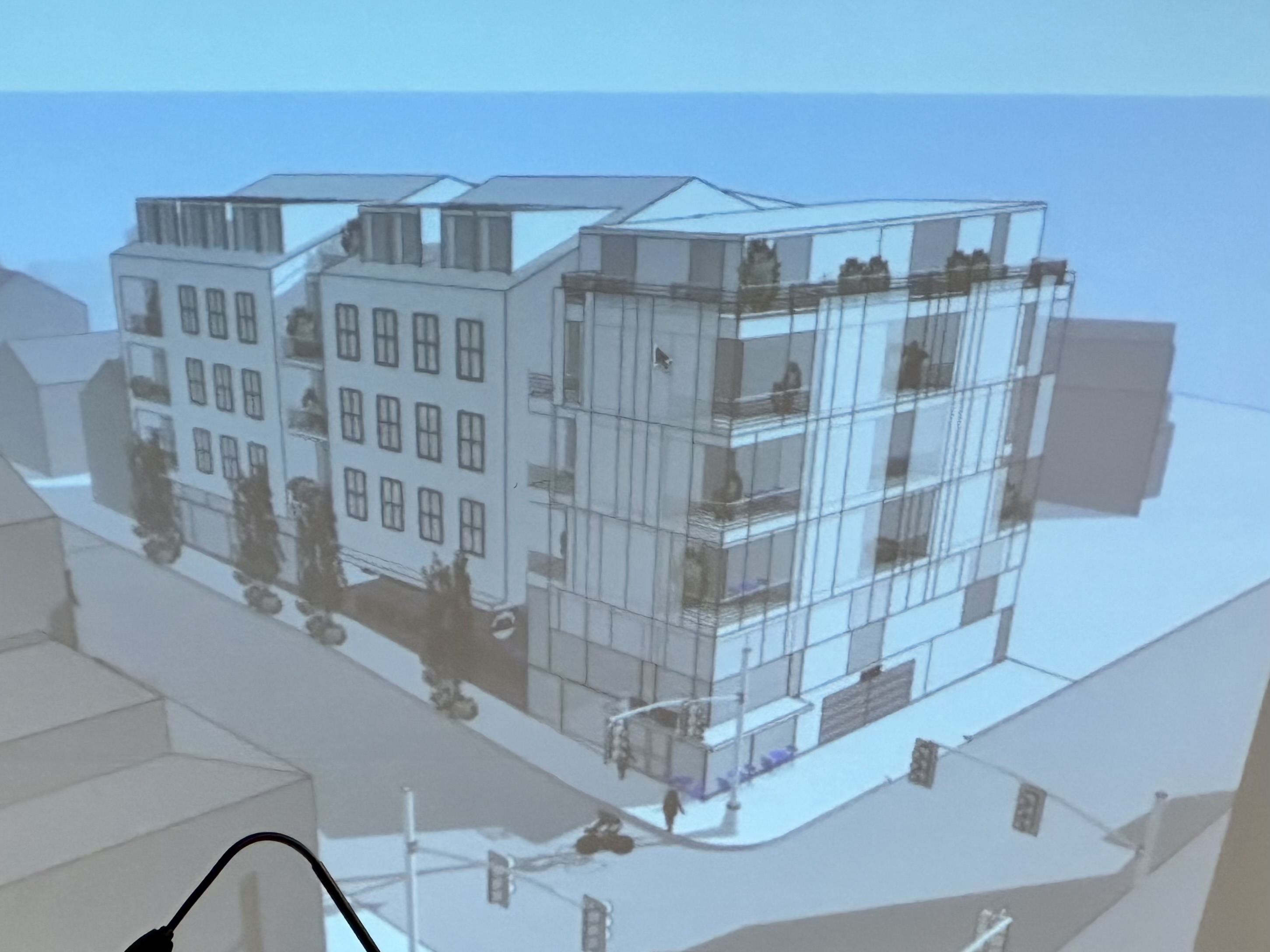 The revised designs show a building that is more broken up than the original plan. 