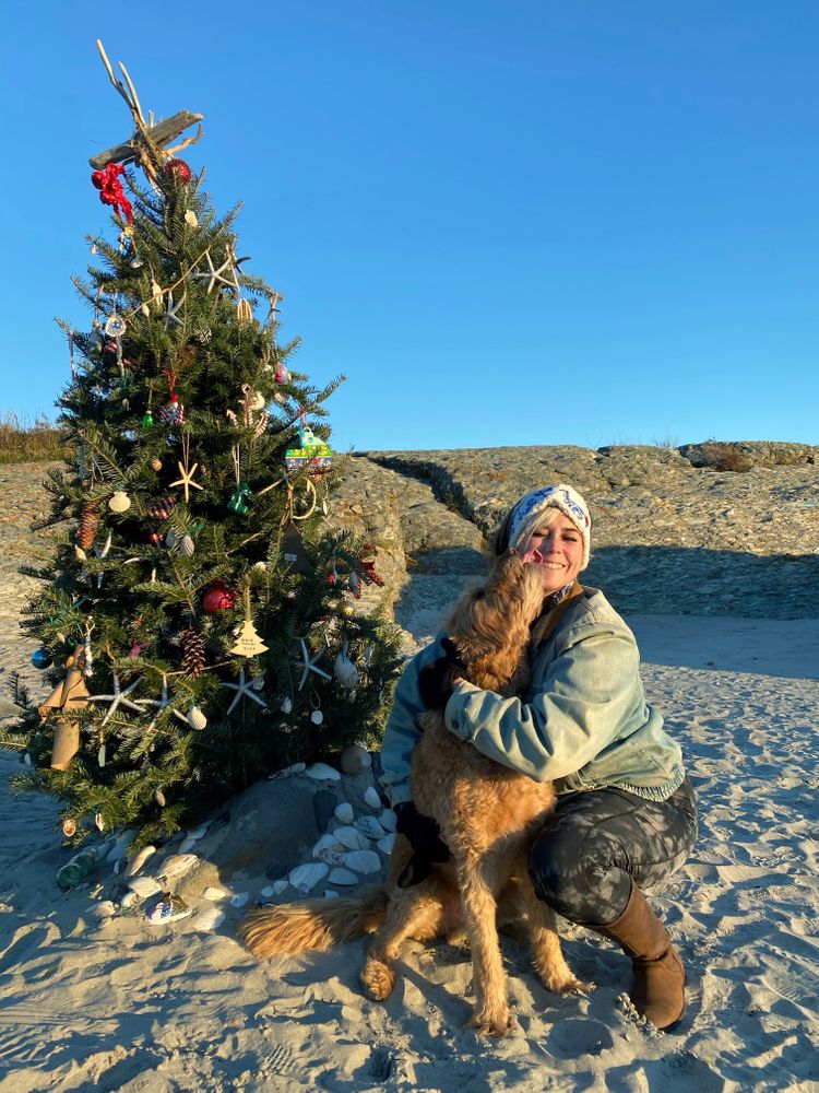 Liz Lirakis, of Middletown, poses for a portrait with her 13-year-old Labradoodle, Barley, at the Sachuest Beach Christmas tree on Tuesday afternoon, Dec. 14, 2021.