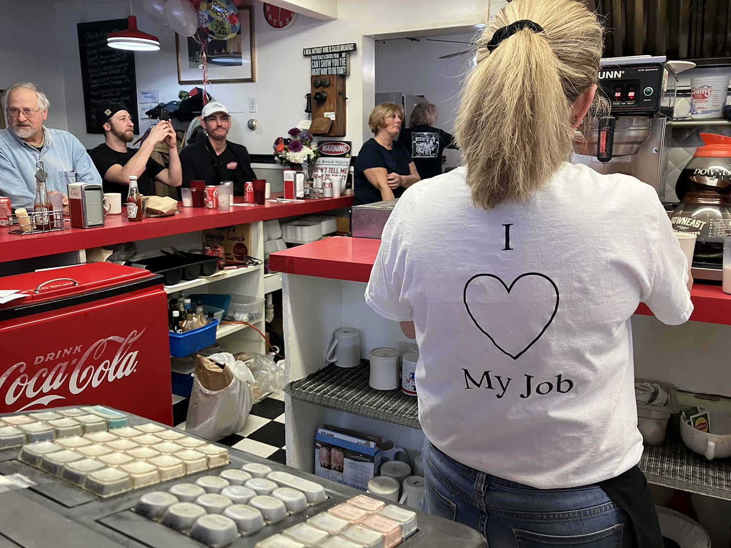 Melanie Hill shows her love for her job as she gets coffee for customers during the lunch rush at Gary's Handy Lunch in downtown Newport on Sunday, Feb. 12, 2023. Gary's Handy Lunch was a beloved local diner on Thames Street for more than 55 years.
