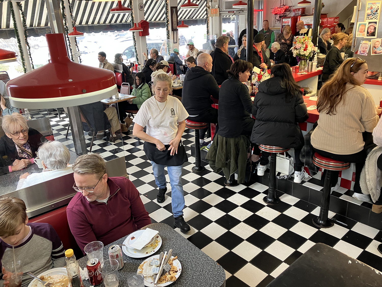 Melanie Hill heads to a table during the lunch rush on Friday, Jan. 27, 2023. She's worked at Gary's Handy Lunch for 37 years. Customers packed the beloved diner for weeks before it closed its doors for the last time on Sunday, Feb. 12, 2023.