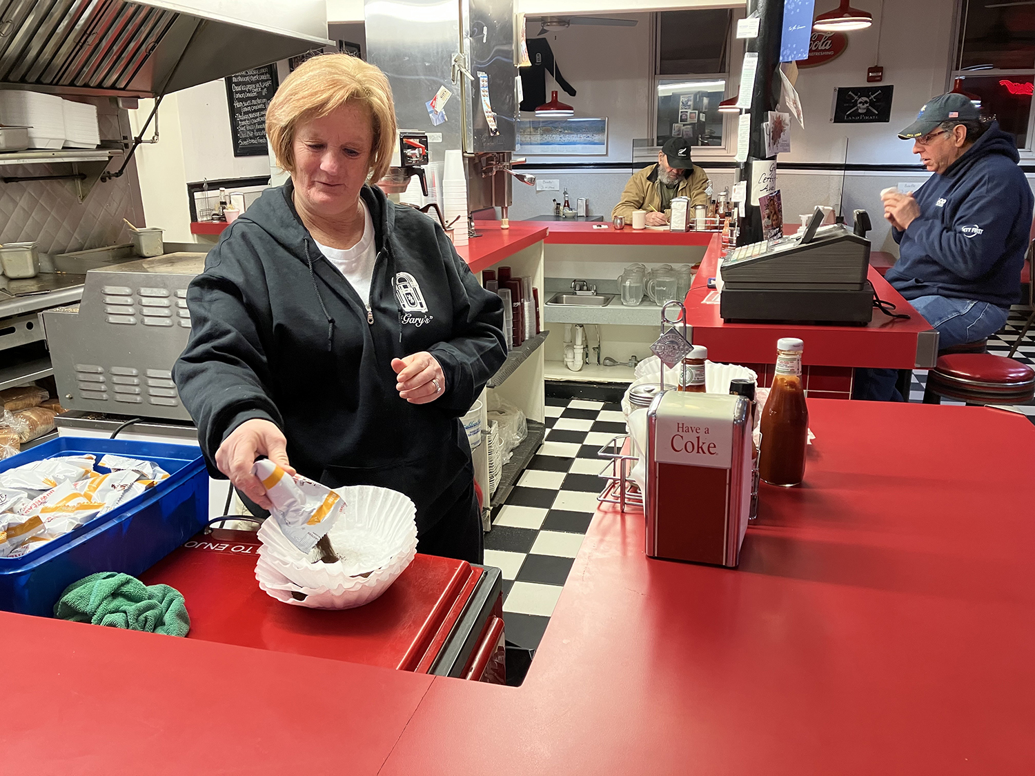 First thing in the morning, Leanne Hamilton preps coffee for the day on Tuesday, Jan. 24, 2023. Hamilton owns her own restaurant, Chelsea's in Middletown, but she still comes to work at Gary's Handy Lunch, her family's diner, once a week.