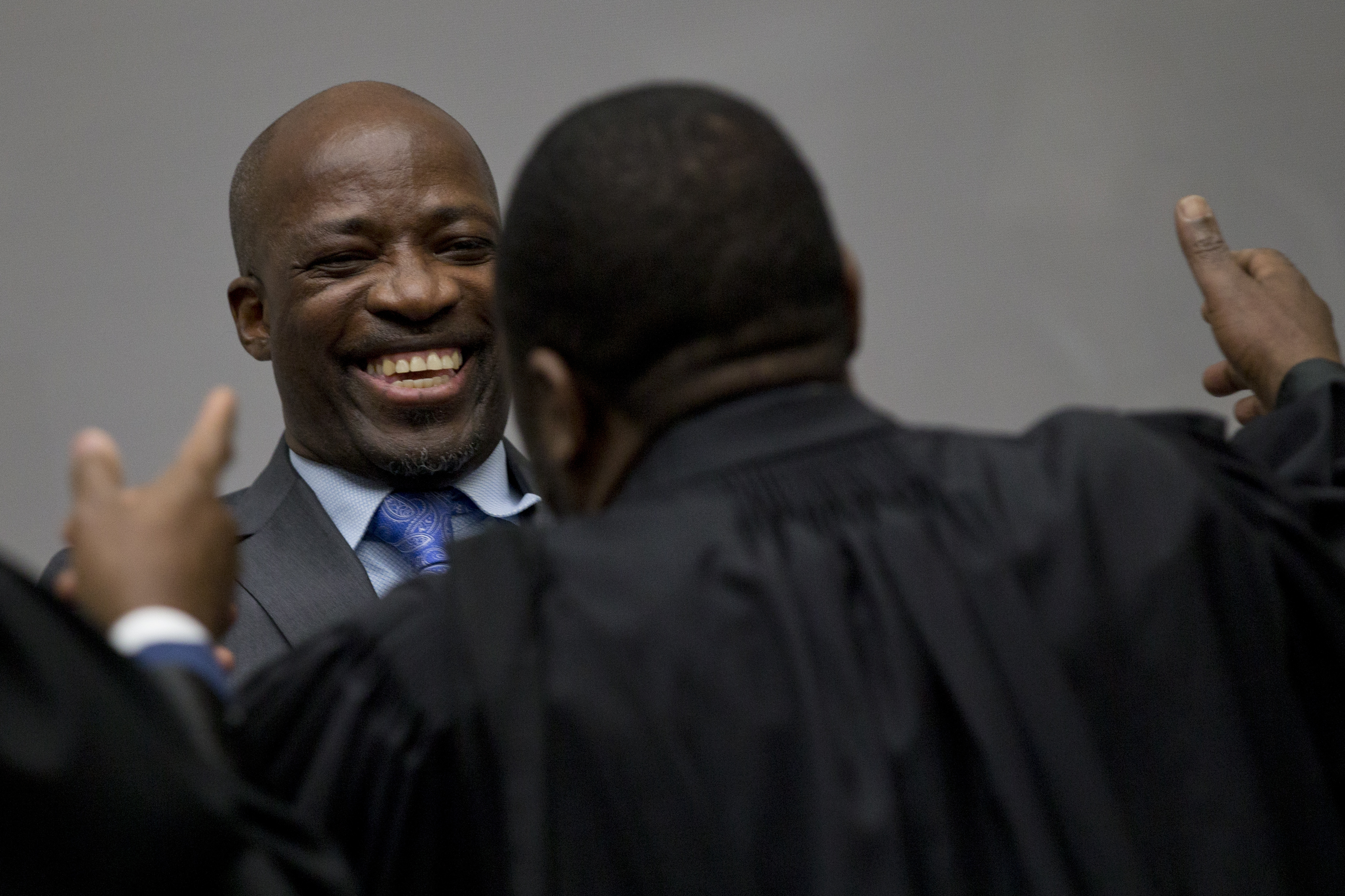 Charles Ble Goude hugs his legal team as he and former Ivory Coast President Laurent Gbagbo enter the courtroom of the International Criminal Court in The Hague, Netherlands, Tuesday, Jan. 15, 2019, where judges were expected to issue rulings on requests by Gbagbo and ex-government minister Goude to have their prosecutions thrown out for lack of evidence. (AP Photo/Peter Dejong, Pool) Charles Ble Goude hugs his legal team as he and former Ivory Coast President Laurent Gbagbo enter the courtroom of the International Criminal Court in The Hague, Netherlands, Tuesday, Jan. 15, 2019, where judges were expected to issue rulings on requests by Gbagbo and ex-government minister Goude to have their prosecutions thrown out for lack of evidence. (AP Photo/Peter Dejong, Pool)