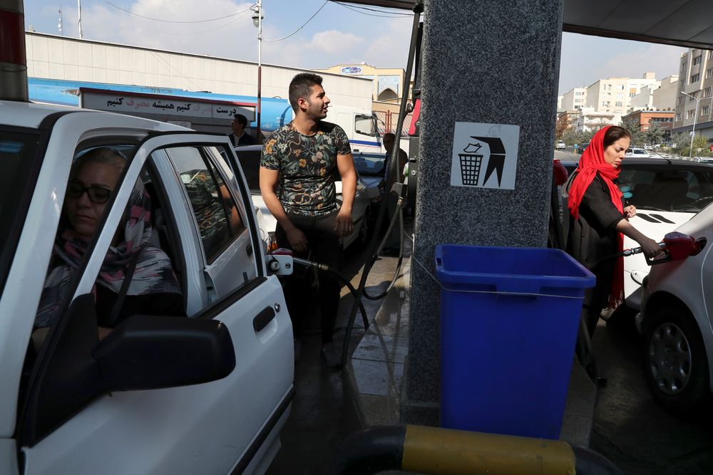 People fill their cars at a gas station in Tehran, Iran, Friday, Nov. 15, 2019. Authorities have imposed rationing and increased the prices of fuel. The decision came following months of speculations about possible rationing after the U.S. in 2018 reimposed sanctions that sent Iran's economy into free-fall following Washington withdrawal from 2015 nuclear deal between Iran and world powers. (AP Photo/Vahid Salemi) People fill their cars at a gas station in Tehran, Iran, Friday, Nov. 15, 2019. Authorities have imposed rationing and increased the prices of fuel. The decision came following months of speculations about possible rationing after the U.S. in 2018 reimposed sanctions that sent Iran's economy into free-fall following Washington withdrawal from 2015 nuclear deal between Iran and world powers. (AP Photo/Vahid Salemi)