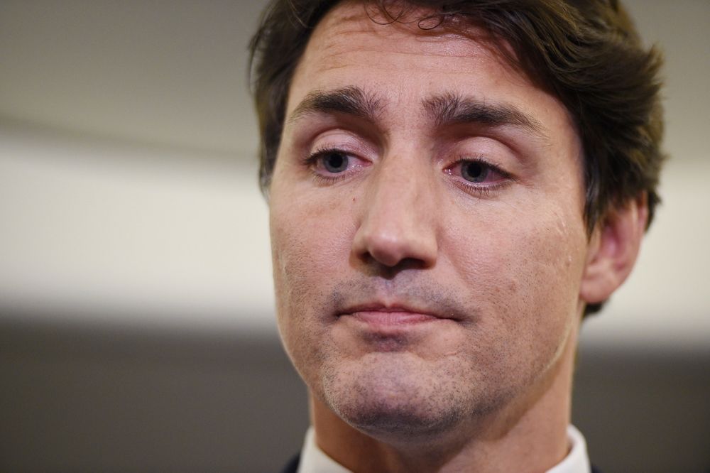 Canadian Prime Minister and Liberal Party leader Justin Trudeau reacts as he makes a statement in regards to a photo coming to light of himself from 2001, wearing Canadian Prime Minister and Liberal Party leader Justin Trudeau reacts as he makes a statement in regards to a photo coming to light of himself from 2001, wearing