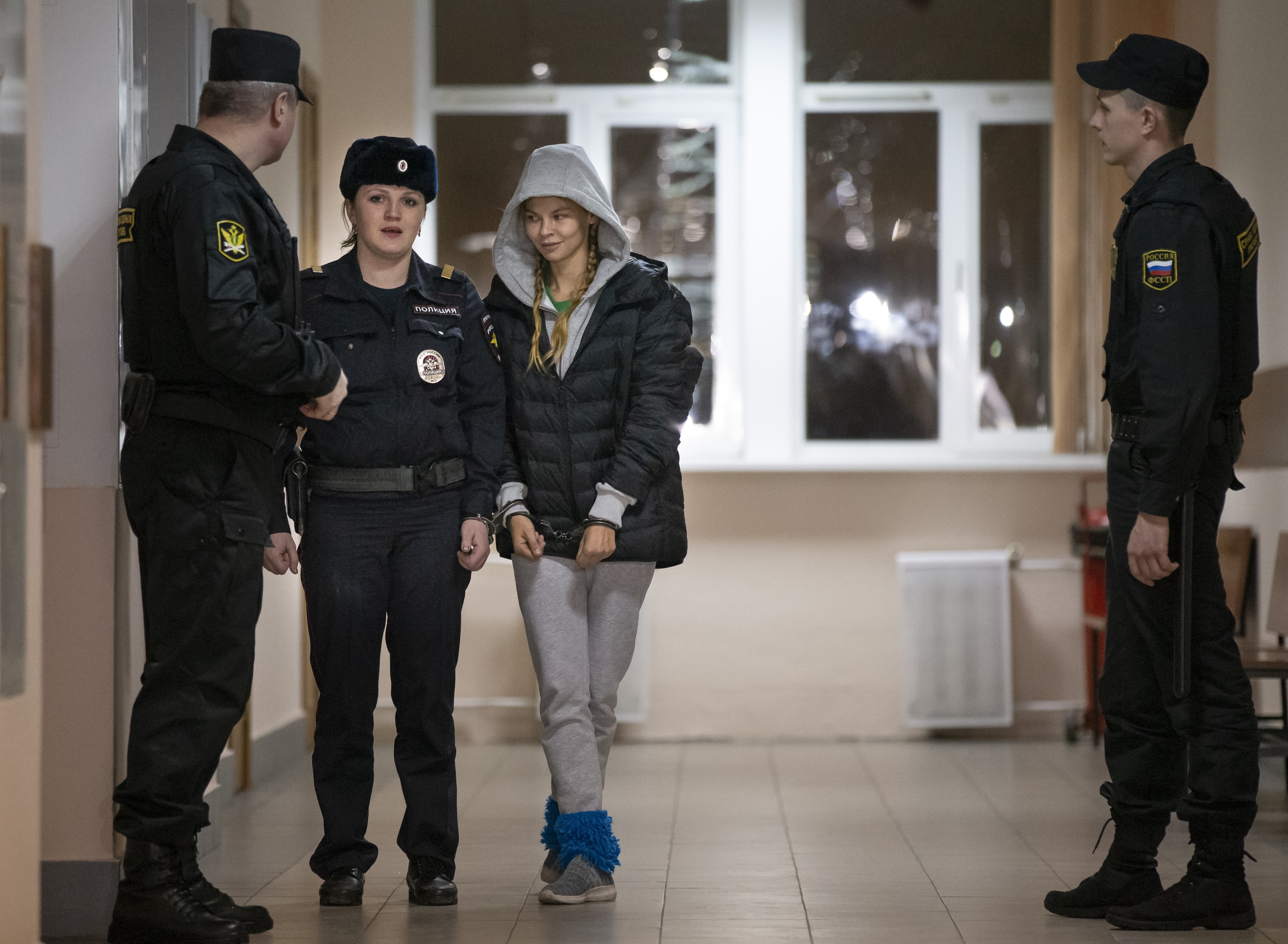Anastasia Vashukevich, also known on social media as Nastya Rybka, center, is escorted in the court room in Moscow, Russia, Saturday, Jan. 19, 2019. A Belarusian model who claimed last year that she had evidence of Russian interference in the election of Donald Trump as U.S. president was arrested immediately upon her arrival in Moscow on Thursday following deportation from Thailand. (AP Photo/Alexander Zemlianichenko) Anastasia Vashukevich, also known on social media as Nastya Rybka, center, is escorted in the court room in Moscow, Russia, Saturday, Jan. 19, 2019. A Belarusian model who claimed last year that she had evidence of Russian interference in the election of Donald Trump as U.S. president was arrested immediately upon her arrival in Moscow on Thursday following deportation from Thailand. (AP Photo/Alexander Zemlianichenko)