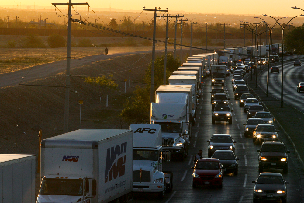 FILE- In this April 9, 2019, file photo, trucks wait to cross the border with the U.S. in Ciudad Juarez, Mexico. In a surprise announcement that could compromise a major trade deal, President Donald Trump announced Thursday that he is slapping a 5% tariff on all Mexican imports to pressure the country to do more to crack down on the surge of Central American migrants trying to cross the U.S. border. (AP Photo/Christian Torres, File) FILE- In this April 9, 2019, file photo, trucks wait to cross the border with the U.S. in Ciudad Juarez, Mexico. In a surprise announcement that could compromise a major trade deal, President Donald Trump announced Thursday that he is slapping a 5% tariff on all Mexican imports to pressure the country to do more to crack down on the surge of Central American migrants trying to cross the U.S. border. (AP Photo/Christian Torres, File)