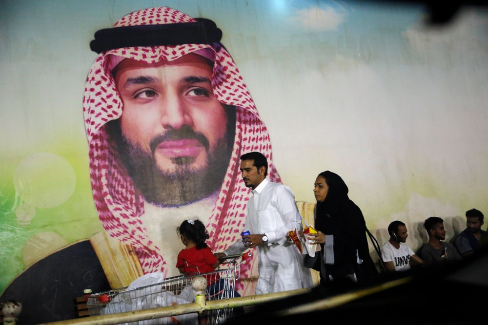 A Saudi family walk past a giant poster of Saudi Crown Prince Mohammed bin Salman, at a shopping mall in Jiddah, Saudi Arabia, Sunday, Sept. 15, 2019. The weekend drone attack on one of the world's largest crude oil processing plants that dramatically cut into global oil supplies is the most visible sign yet of how Aramco's stability and security is directly linked to that of its owner -- the Saudi government and its ruling family. (AP Photo/Amr Nabil) A Saudi family walk past a giant poster of Saudi Crown Prince Mohammed bin Salman, at a shopping mall in Jiddah, Saudi Arabia, Sunday, Sept. 15, 2019. The weekend drone attack on one of the world's largest crude oil processing plants that dramatically cut into global oil supplies is the most visible sign yet of how Aramco's stability and security is directly linked to that of its owner -- the Saudi government and its ruling family. (AP Photo/Amr Nabil)