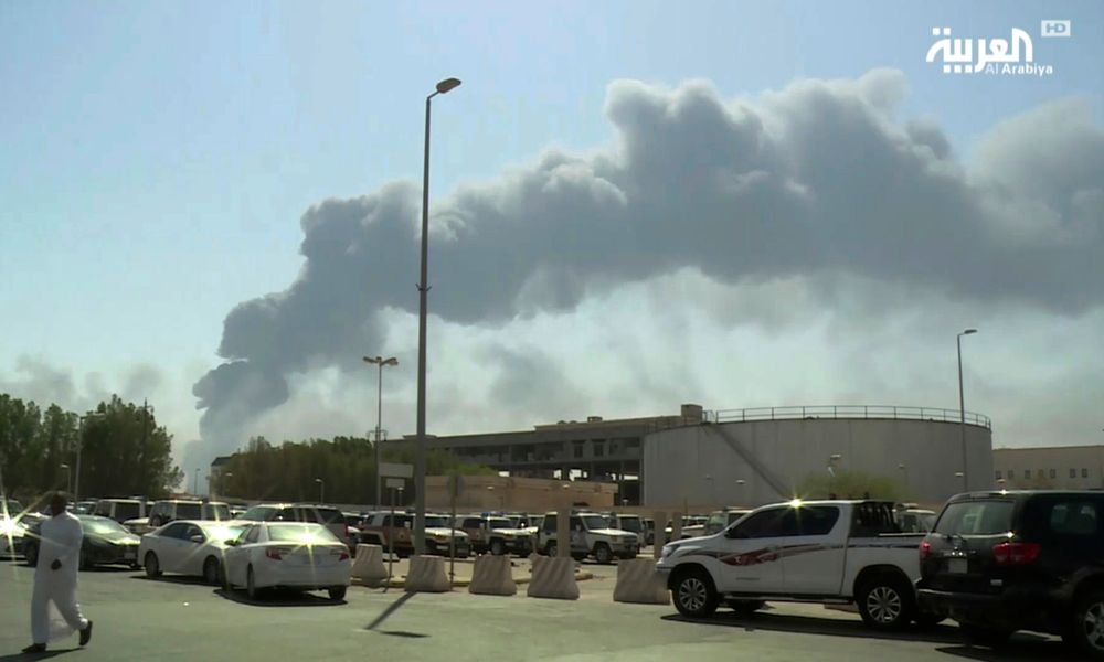 FILE - In this Saturday, Sept. 14, 2019 file photo, made from a video broadcast on the Saudi-owned Al-Arabiya satellite news channel, smoke from a fire at the Abqaiq oil processing facility fills the skyline, in Buqyaq, Saudi Arabia. The weekend drone attack on one of the world’s largest crude oil processing plants that dramatically cut into global oil supplies is the most visible sign yet of how Aramco’s stability and security is directly linked to that of its owner -- the Saudi government and its ruling family. (Al-Arabiya via AP, File) FILE - In this Saturday, Sept. 14, 2019 file photo, made from a video broadcast on the Saudi-owned Al-Arabiya satellite news channel, smoke from a fire at the Abqaiq oil processing facility fills the skyline, in Buqyaq, Saudi Arabia. The weekend drone attack on one of the world’s largest crude oil processing plants that dramatically cut into global oil supplies is the most visible sign yet of how Aramco’s stability and security is directly linked to that of its owner -- the Saudi government and its ruling family. (Al-Arabiya via AP, File)