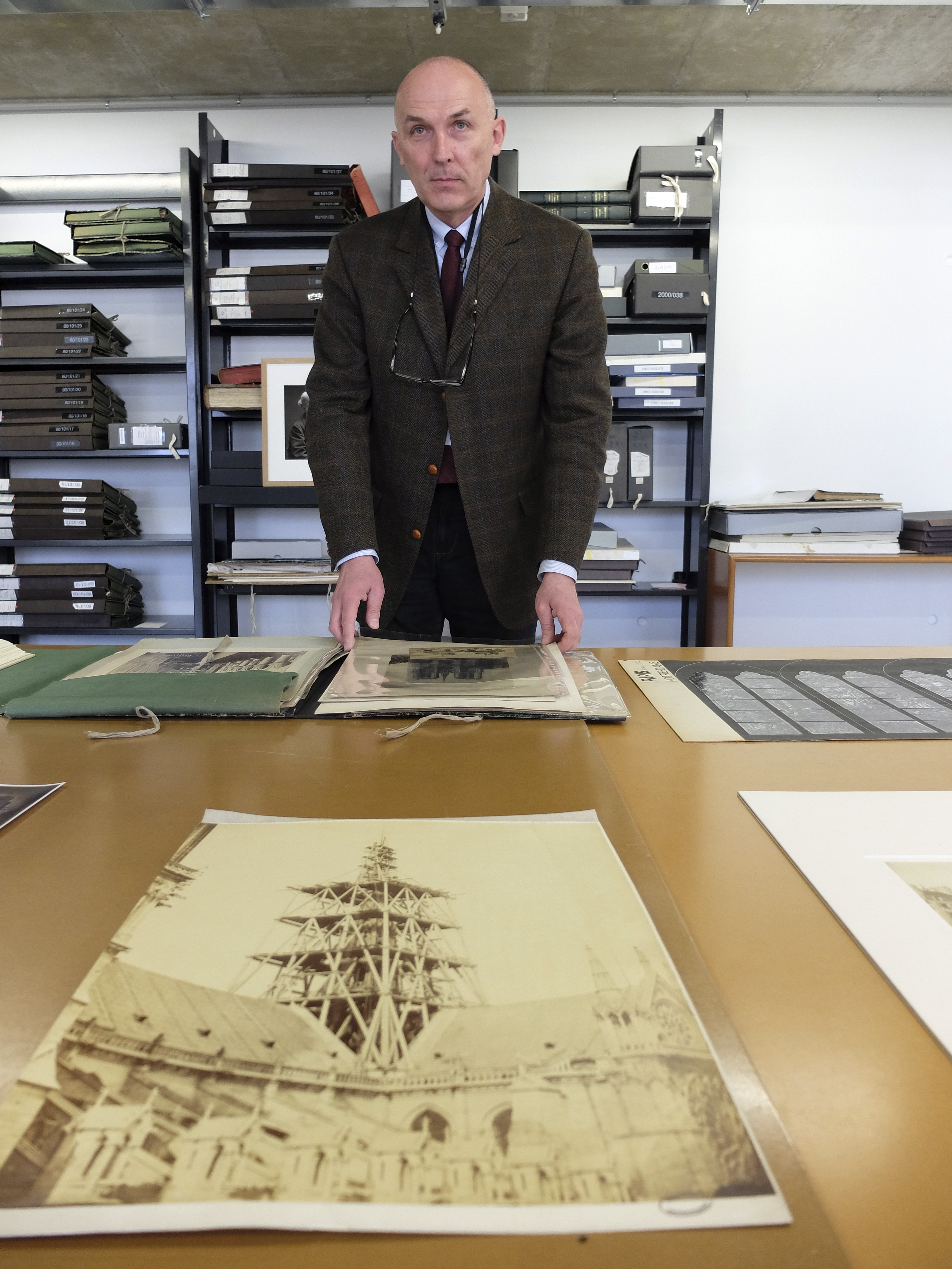 Jean-Charles Forgeret poses with archives documents related to Notre Dame cathedral in Charenton le Pont, outside Paris, Thursday, April 18, 2019. The reconstruction of Paris' Notre Dame Cathedral will rely on part on extensive plans drawn up in the 19th century for its last big renovation. Forgeret noted that the last restoration took 20 years, and cast doubt on the French president's 5-year deadline on fixing Notre Dame this time. (AP Photo/Nicolas Garriga) Jean-Charles Forgeret poses with archives documents related to Notre Dame cathedral in Charenton le Pont, outside Paris, Thursday, April 18, 2019. The reconstruction of Paris' Notre Dame Cathedral will rely on part on extensive plans drawn up in the 19th century for its last big renovation. Forgeret noted that the last restoration took 20 years, and cast doubt on the French president's 5-year deadline on fixing Notre Dame this time. (AP Photo/Nicolas Garriga)