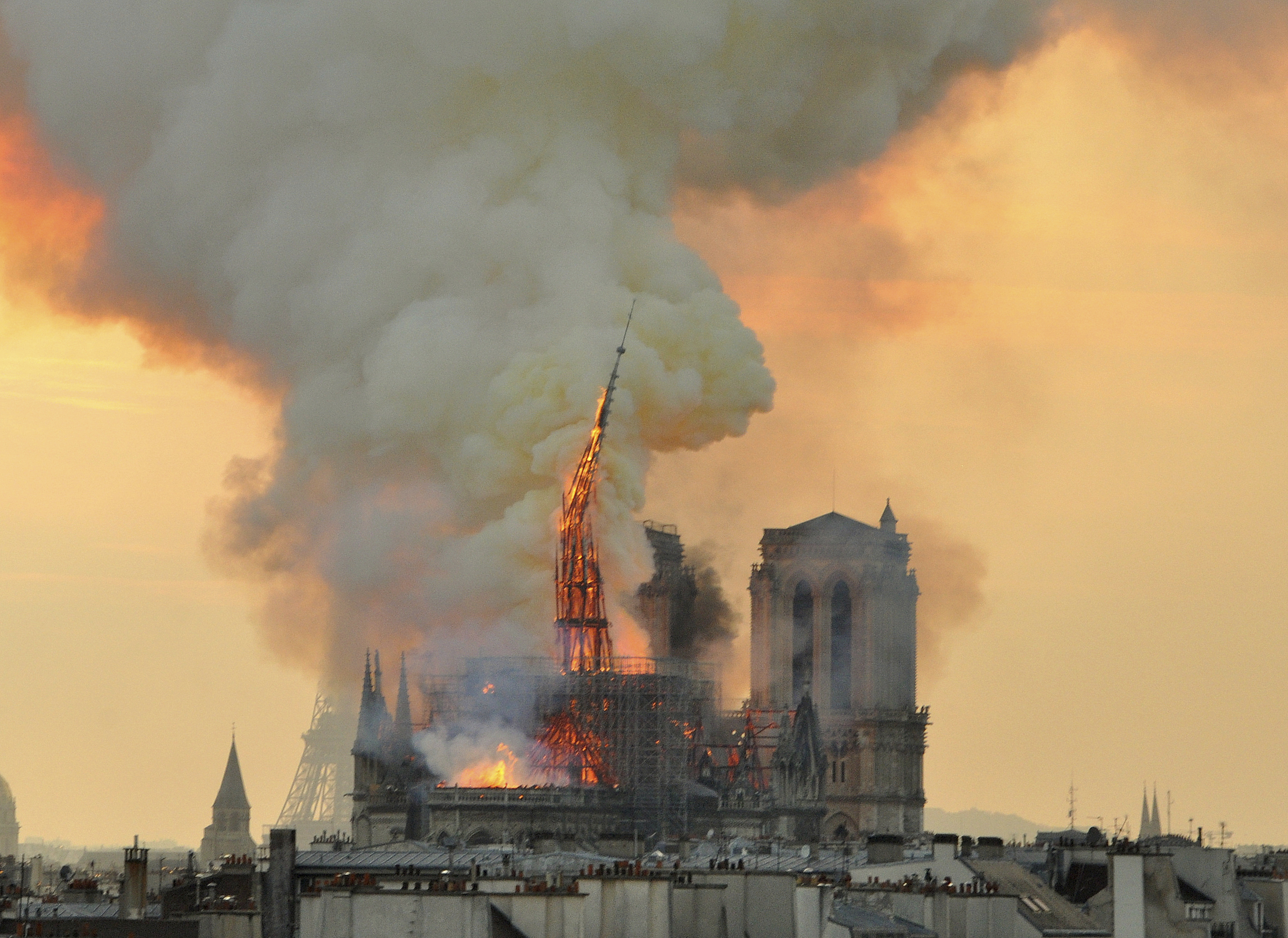 In this image made available on Tuesday April 16, 2019 flames and smoke rise from the blaze as the spire starts to topple on Notre Dame cathedral in Paris, Monday, April 15, 2019. An inferno that raged through Notre Dame Cathedral for more than 12 hours destroyed its spire and its roof but spared its twin medieval bell towers, and a frantic rescue effort saved the monument's In this image made available on Tuesday April 16, 2019 flames and smoke rise from the blaze as the spire starts to topple on Notre Dame cathedral in Paris, Monday, April 15, 2019. An inferno that raged through Notre Dame Cathedral for more than 12 hours destroyed its spire and its roof but spared its twin medieval bell towers, and a frantic rescue effort saved the monument's