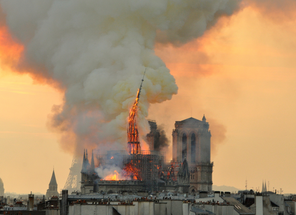 In this image made available on Tuesday April 16, 2019 flames and smoke rise from the blaze as the spire starts to topple on Notre Dame cathedral in Paris, Monday, April 15, 2019. An inferno that raged through Notre Dame Cathedral for more than 12 hours destroyed its spire and its roof but spared its twin medieval bell towers, and a frantic rescue effort saved the monument's In this image made available on Tuesday April 16, 2019 flames and smoke rise from the blaze as the spire starts to topple on Notre Dame cathedral in Paris, Monday, April 15, 2019. An inferno that raged through Notre Dame Cathedral for more than 12 hours destroyed its spire and its roof but spared its twin medieval bell towers, and a frantic rescue effort saved the monument's