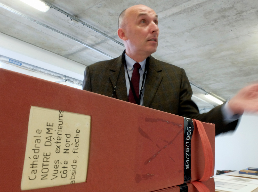 Jean-Charles Forgeret poses with files related to Notre Dame cathedral in Charenton le Pont, outside Paris, Thursday, April 18, 2019. The reconstruction of Paris' Notre Dame Cathedral will rely on part on extensive plans drawn up in the 19th century for its last big renovation. Forgeret noted that the last restoration took 20 years, and cast doubt on the French president's 5-year deadline on fixing Notre Dame this time. (AP Photo/Nicolas Garriga) Jean-Charles Forgeret poses with files related to Notre Dame cathedral in Charenton le Pont, outside Paris, Thursday, April 18, 2019. The reconstruction of Paris' Notre Dame Cathedral will rely on part on extensive plans drawn up in the 19th century for its last big renovation. Forgeret noted that the last restoration took 20 years, and cast doubt on the French president's 5-year deadline on fixing Notre Dame this time. (AP Photo/Nicolas Garriga)