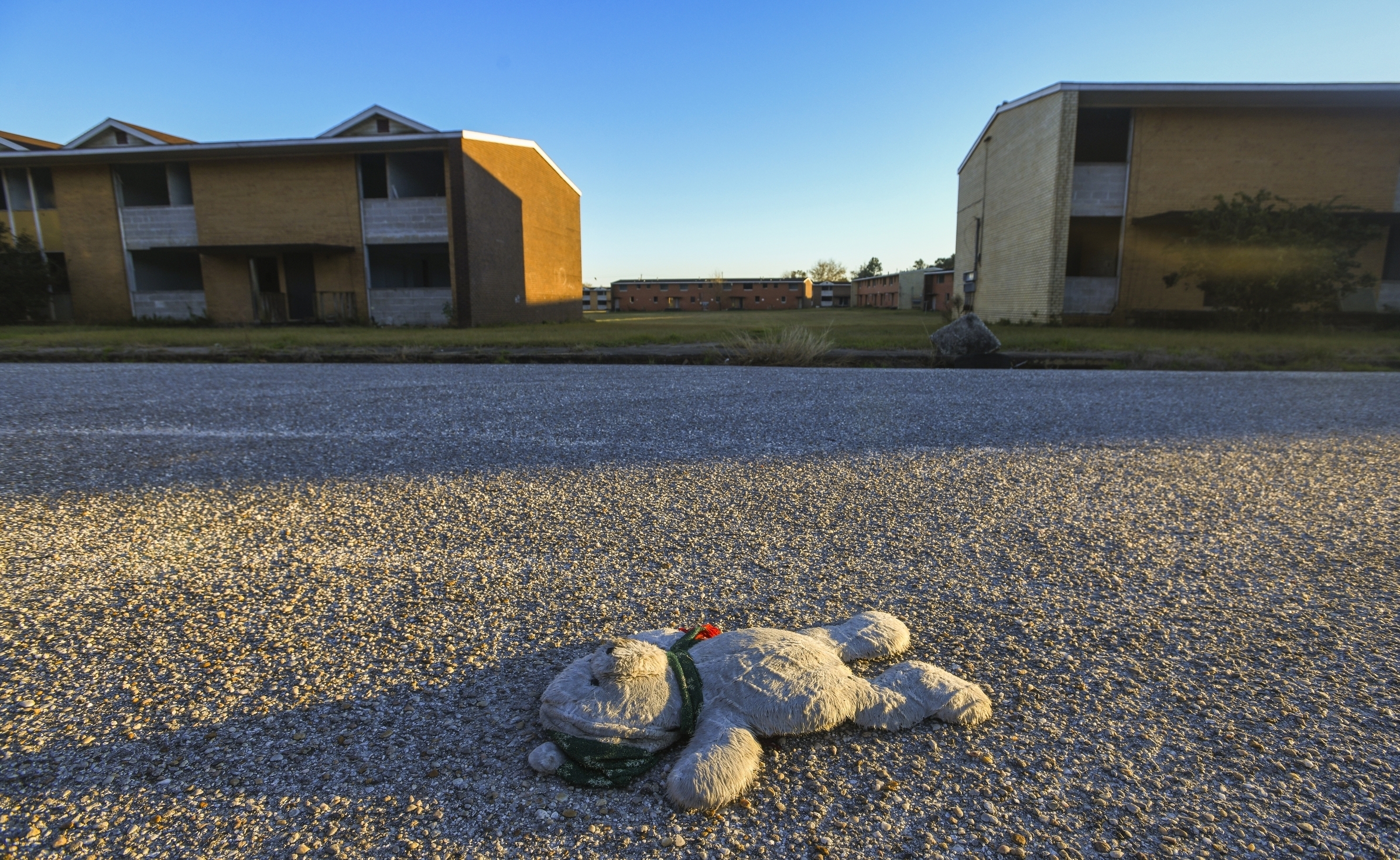 A teddy bear lies in the middle of Franklin Drive in what's known as the Africatown's Happy Hills community in Mobile, Ala., on Tuesday, Jan. 29, 2019. The Josephine Allen housing project stands abandoned in the background. (AP Photo/Julie Bennett) A teddy bear lies in the middle of Franklin Drive in what's known as the Africatown's Happy Hills community in Mobile, Ala., on Tuesday, Jan. 29, 2019. The Josephine Allen housing project stands abandoned in the background. (AP Photo/Julie Bennett)
