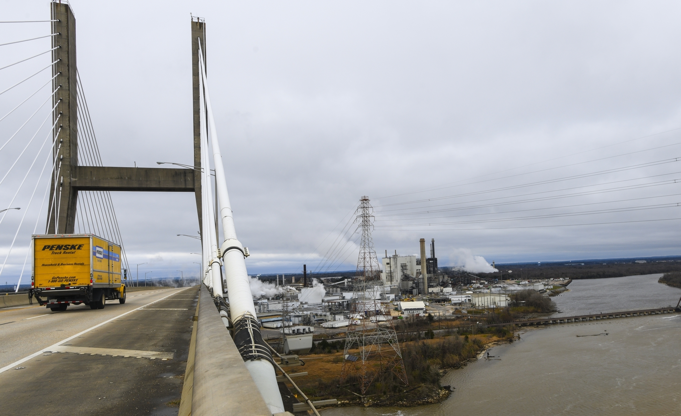 Industrial development occupies the Mobile Riverfront under the Cochrane-Africatown bridge near Mobile, Ala., on Tuesday, Jan. 29, 2019. Industrial development choked off access to the Mobile River and Chickasaw Creek, where generations in Africatown caught crabs and fish. Factories now occupy land that once held modest homes surrounded by gardens, fruit trees and clucking chickens. The population has plummeted; many of the remaining homes are boarded up and rotting. (AP Photo/Julie Bennett) Industrial development occupies the Mobile Riverfront under the Cochrane-Africatown bridge near Mobile, Ala., on Tuesday, Jan. 29, 2019. Industrial development choked off access to the Mobile River and Chickasaw Creek, where generations in Africatown caught crabs and fish. Factories now occupy land that once held modest homes surrounded by gardens, fruit trees and clucking chickens. The population has plummeted; many of the remaining homes are boarded up and rotting. (AP Photo/Julie Bennett)
