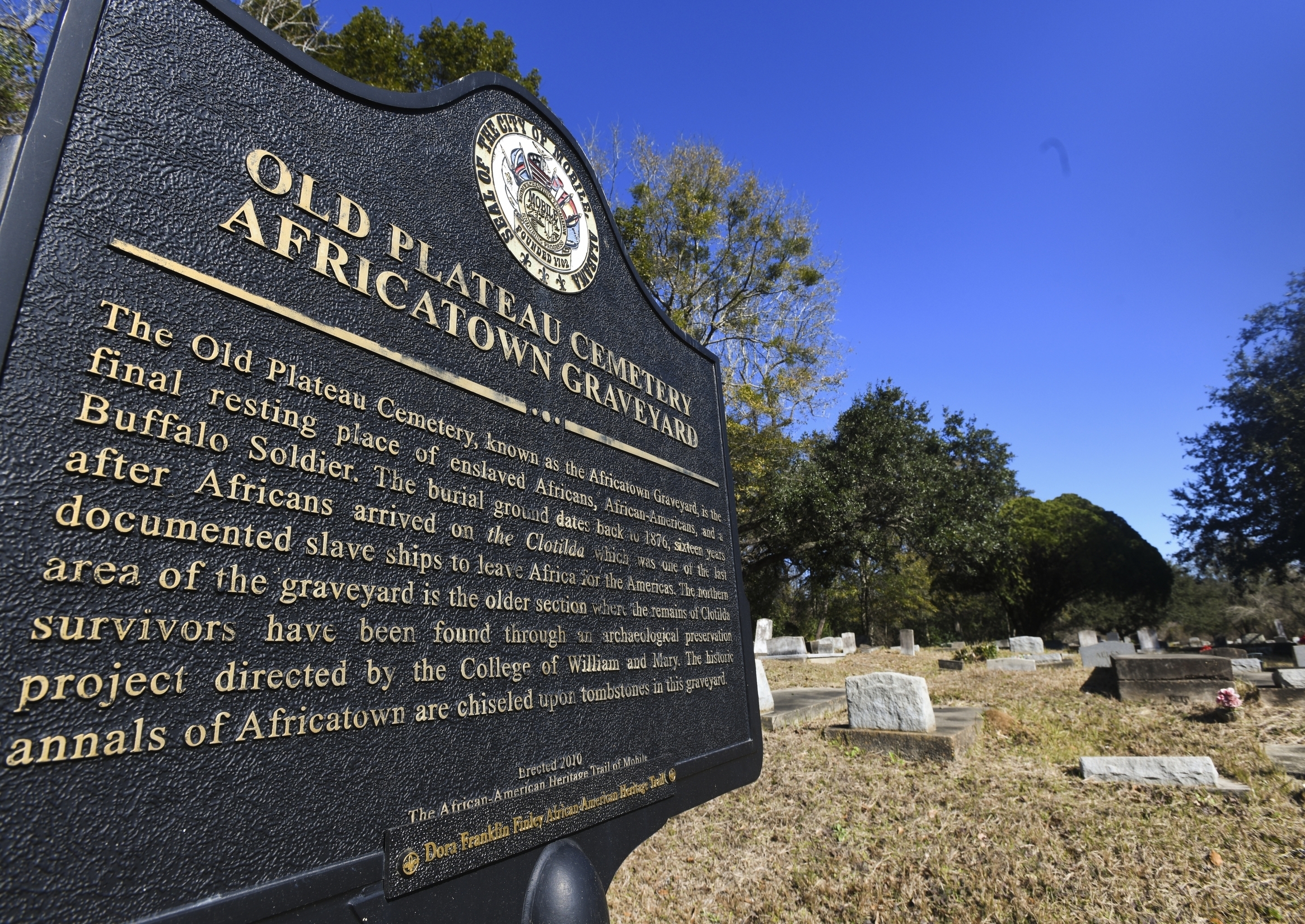 Old Plateau Cemetery, the final resting place for many who spent their lives in Africatown, stands in need of upkeep near Mobile, Ala., on Tuesday, Jan. 29, 2019. Many of the survivors of the Clotilda's voyage are buried here amongst the trees. (AP Photo/Julie Bennett) Old Plateau Cemetery, the final resting place for many who spent their lives in Africatown, stands in need of upkeep near Mobile, Ala., on Tuesday, Jan. 29, 2019. Many of the survivors of the Clotilda's voyage are buried here amongst the trees. (AP Photo/Julie Bennett)