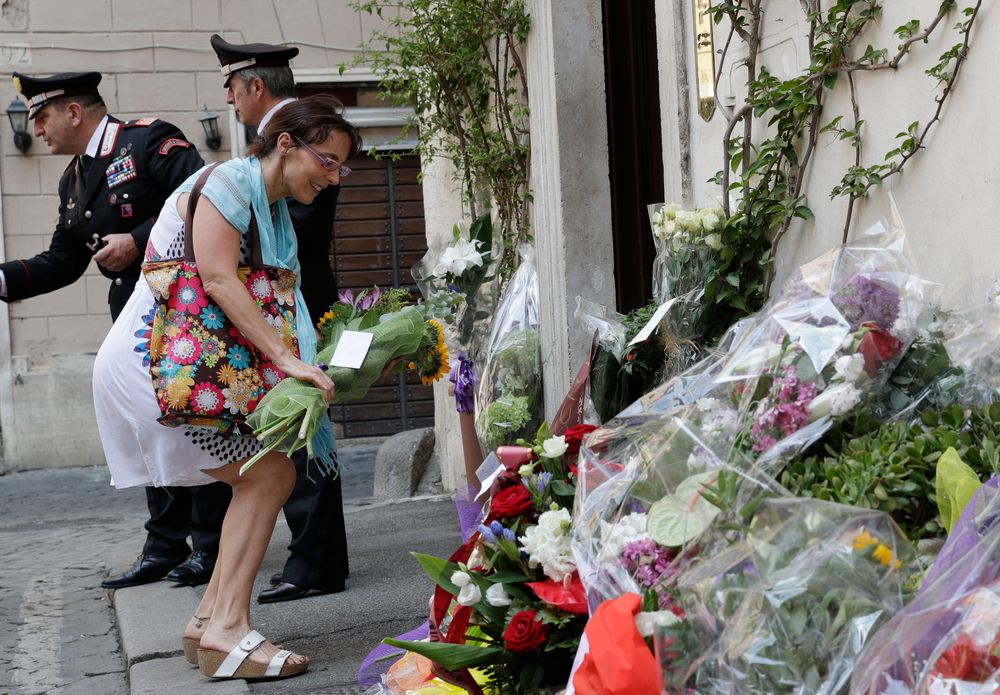 A woman leaves flowers in front of the Carabinieri station where Mario Cerciello Rega was based, in Rome, Saturday, July 27, 2019. In a statement Saturday, Carabinieri officers investigating the death Friday of officer Cerciello Rega, 35, said two American turists, both 19, have been detained for alleged murder and attempted extortion. (AP Photo/Andrew Medichini) A woman leaves flowers in front of the Carabinieri station where Mario Cerciello Rega was based, in Rome, Saturday, July 27, 2019. In a statement Saturday, Carabinieri officers investigating the death Friday of officer Cerciello Rega, 35, said two American turists, both 19, have been detained for alleged murder and attempted extortion. (AP Photo/Andrew Medichini)