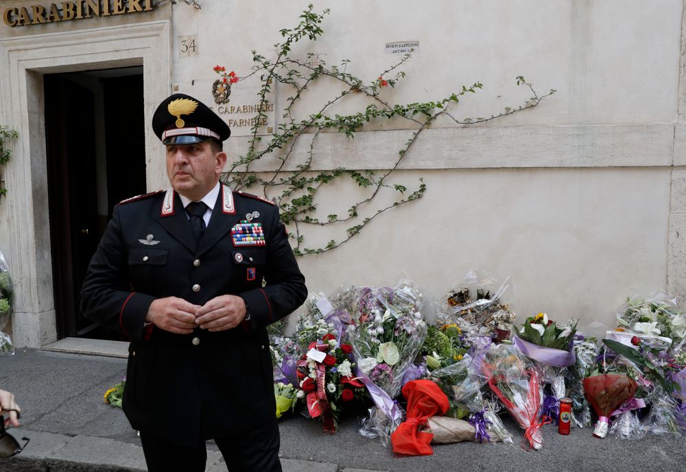 Sandro Ottaviani, commander of the station, stands near flowers left by Roman citizens in front of the Carabinieri station where Mario Cerciello Rega was based, in Rome, Saturday, July 27, 2019. In a statement Saturday, Carabinieri officers investigating the death Friday of officer Cerciello Rega, 35, said two American turists, both 19, have been detained for alleged murder and attempted extortion. (AP Photo/Andrew Medichini) Sandro Ottaviani, commander of the station, stands near flowers left by Roman citizens in front of the Carabinieri station where Mario Cerciello Rega was based, in Rome, Saturday, July 27, 2019. In a statement Saturday, Carabinieri officers investigating the death Friday of officer Cerciello Rega, 35, said two American turists, both 19, have been detained for alleged murder and attempted extortion. (AP Photo/Andrew Medichini)