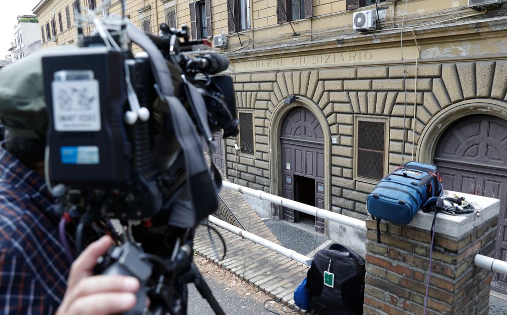 A cameraman waits at the entrance of the Regina Coeli prison, where the alleged murderer of carabiniere Mario Cerciello Rega, who was stabbed to death, are detained in Rome, Saturday, July 27, 2019. In a statement Saturday, Carabinieri officers investigating the death Friday of officer Cerciello Rega, 35, said two American tourists, both 19, have been detained for alleged murder and attempted extortion. (AP Photo/Andrew Medichini) A cameraman waits at the entrance of the Regina Coeli prison, where the alleged murderer of carabiniere Mario Cerciello Rega, who was stabbed to death, are detained in Rome, Saturday, July 27, 2019. In a statement Saturday, Carabinieri officers investigating the death Friday of officer Cerciello Rega, 35, said two American tourists, both 19, have been detained for alleged murder and attempted extortion. (AP Photo/Andrew Medichini)