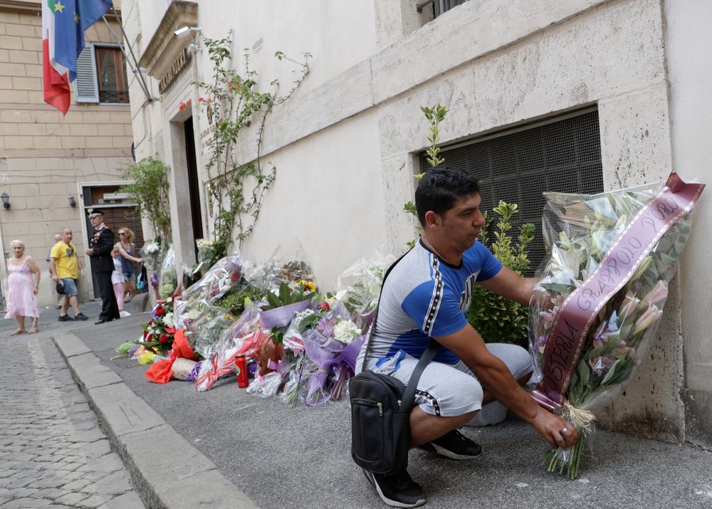 A man leaves flowers in front of the Carabinieri station where Mario Cerciello Rega was based, in Rome, Saturday, July 27, 2019. In a statement Saturday, Carabinieri officers investigating the death Friday of officer Cerciello Rega, 35, said two American turists, both 19, have been detained for alleged murder and attempted extortion. (AP Photo/Andrew Medichini) A man leaves flowers in front of the Carabinieri station where Mario Cerciello Rega was based, in Rome, Saturday, July 27, 2019. In a statement Saturday, Carabinieri officers investigating the death Friday of officer Cerciello Rega, 35, said two American turists, both 19, have been detained for alleged murder and attempted extortion. (AP Photo/Andrew Medichini)