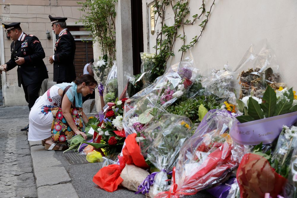 A woman leaves flowers in front of the Carabinieri station where Mario Cerciello Rega was based, in Rome, Saturday, July 27, 2019. In a statement Saturday, Carabinieri officers investigating the death Friday of officer Cerciello Rega, 35, said two American turists, both 19, have been detained for alleged murder and attempted extortion. (AP Photo/Andrew Medichini) A woman leaves flowers in front of the Carabinieri station where Mario Cerciello Rega was based, in Rome, Saturday, July 27, 2019. In a statement Saturday, Carabinieri officers investigating the death Friday of officer Cerciello Rega, 35, said two American turists, both 19, have been detained for alleged murder and attempted extortion. (AP Photo/Andrew Medichini)