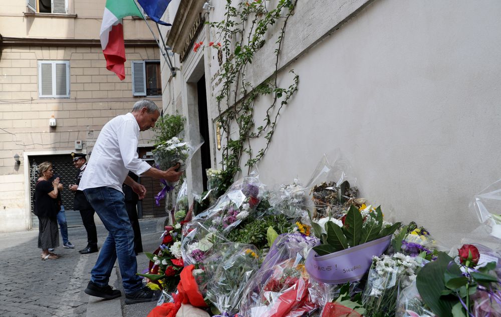 A man leaves flowers in front of the Carabinieri station where Mario Cerciello Rega was based, in Rome, Saturday, July 27, 2019. In a statement Saturday, Carabinieri officers investigating the death Friday of officer Cerciello Rega, 35, said two American turists, both 19, have been detained for alleged murder and attempted extortion. (AP Photo/Andrew Medichini) A man leaves flowers in front of the Carabinieri station where Mario Cerciello Rega was based, in Rome, Saturday, July 27, 2019. In a statement Saturday, Carabinieri officers investigating the death Friday of officer Cerciello Rega, 35, said two American turists, both 19, have been detained for alleged murder and attempted extortion. (AP Photo/Andrew Medichini)