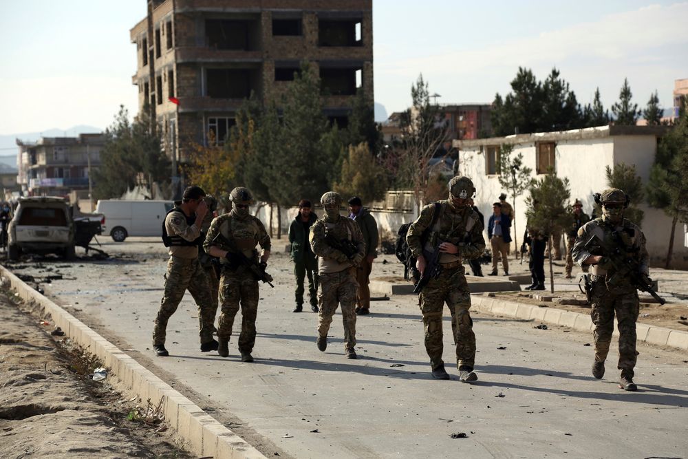 Foreign and local security personnel gather at the site of car bomb attack in Kabul, Afghanistan, Wednesday, Nov. 13, 2019. A car bomb detonated in the Afghan capital during Wednesday's morning commute, killing seven people and wounding at least seven, officials said. (AP Photo/Rahmat Gul) Foreign and local security personnel gather at the site of car bomb attack in Kabul, Afghanistan, Wednesday, Nov. 13, 2019. A car bomb detonated in the Afghan capital during Wednesday's morning commute, killing seven people and wounding at least seven, officials said. (AP Photo/Rahmat Gul)