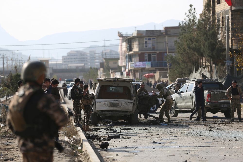 Foreign and local security personnel gather at the site of car bomb attack in the Kabul, Afghanistan, Wednesday, Nov. 13, 2019. A car bomb detonated in the Afghan capital during Wednesday's morning commute, killing seven people and wounding at least seven, officials said. (AP Photo/Rahmat Gul) Foreign and local security personnel gather at the site of car bomb attack in the Kabul, Afghanistan, Wednesday, Nov. 13, 2019. A car bomb detonated in the Afghan capital during Wednesday's morning commute, killing seven people and wounding at least seven, officials said. (AP Photo/Rahmat Gul)