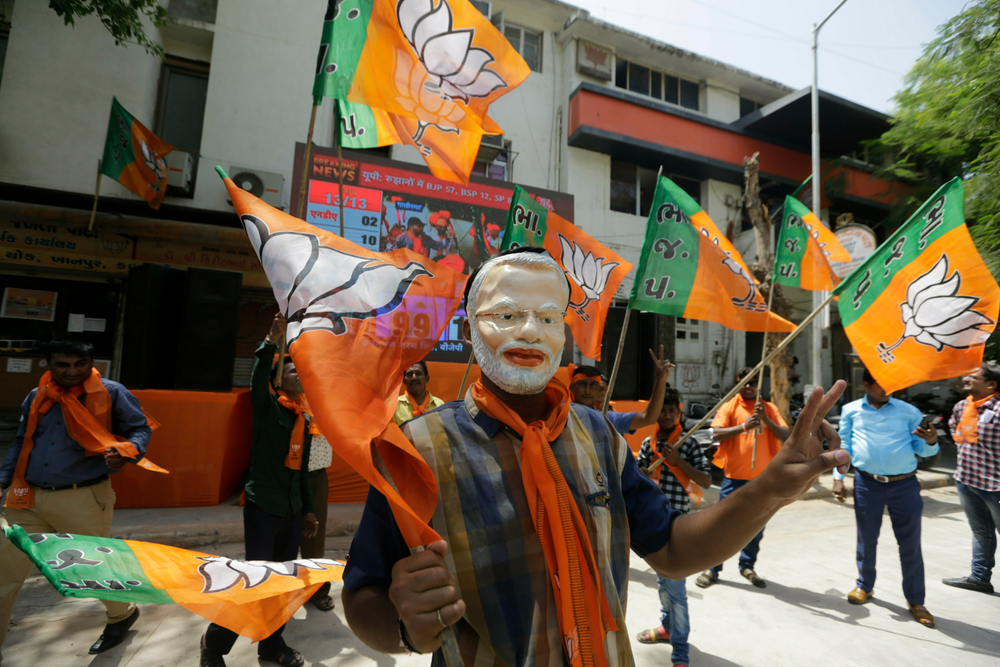 A supporters of India's ruling Bharatiya Janata Party wears mask of Indian Prime Minister Narendra Modi as he celebrates early trends of party's victory in general elections in Ahmadabad, India, Thursday, May 23, 2019. Modi and his party were off to an early lead as vote counting began Thursday following the conclusion of the country's 6-week-long general election, sending the stock market soaring in anticipation of another five-year term for the Hindu nationalist leader. (AP Photo/Ajit Solanki) A supporters of India's ruling Bharatiya Janata Party wears mask of Indian Prime Minister Narendra Modi as he celebrates early trends of party's victory in general elections in Ahmadabad, India, Thursday, May 23, 2019. Modi and his party were off to an early lead as vote counting began Thursday following the conclusion of the country's 6-week-long general election, sending the stock market soaring in anticipation of another five-year term for the Hindu nationalist leader. (AP Photo/Ajit Solanki)