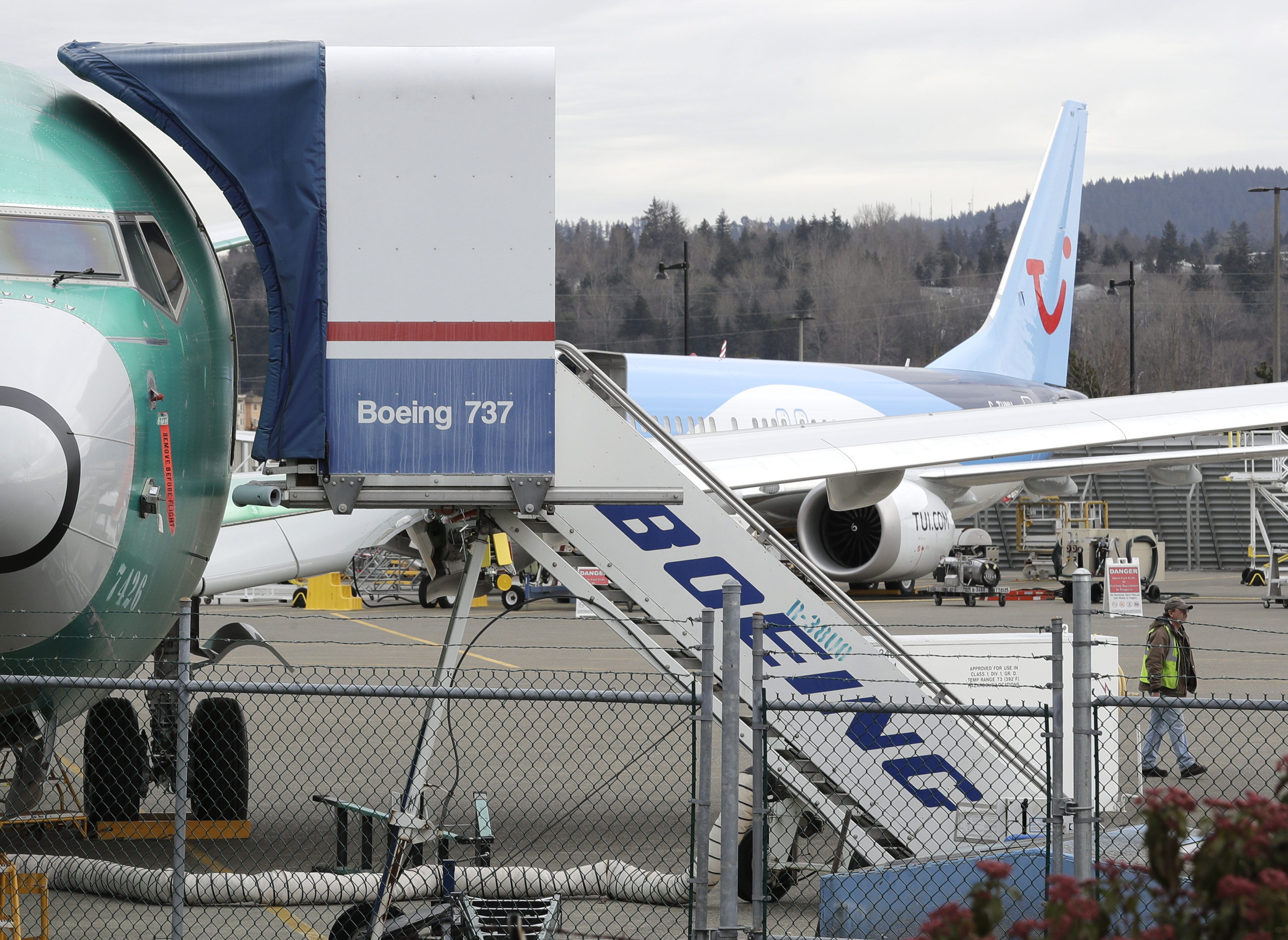 In this photo taken Monday, March 11, 2019, a Boeing 737 MAX 8 airplane being built for TUI Group sits parked in the background at right at Boeing Co.'s Renton Assembly Plant in Renton, Wash. Britain, France and Germany on Tuesday joined a rapidly growing number of countries grounding the new Boeing plane involved in the Ethiopian Airlines disaster or turning it back from their airspace, while investigators in Ethiopia looked for parallels with a similar crash just five months ago. (AP Photo/Ted S. Warren) In this photo taken Monday, March 11, 2019, a Boeing 737 MAX 8 airplane being built for TUI Group sits parked in the background at right at Boeing Co.'s Renton Assembly Plant in Renton, Wash. Britain, France and Germany on Tuesday joined a rapidly growing number of countries grounding the new Boeing plane involved in the Ethiopian Airlines disaster or turning it back from their airspace, while investigators in Ethiopia looked for parallels with a similar crash just five months ago. (AP Photo/Ted S. Warren)
