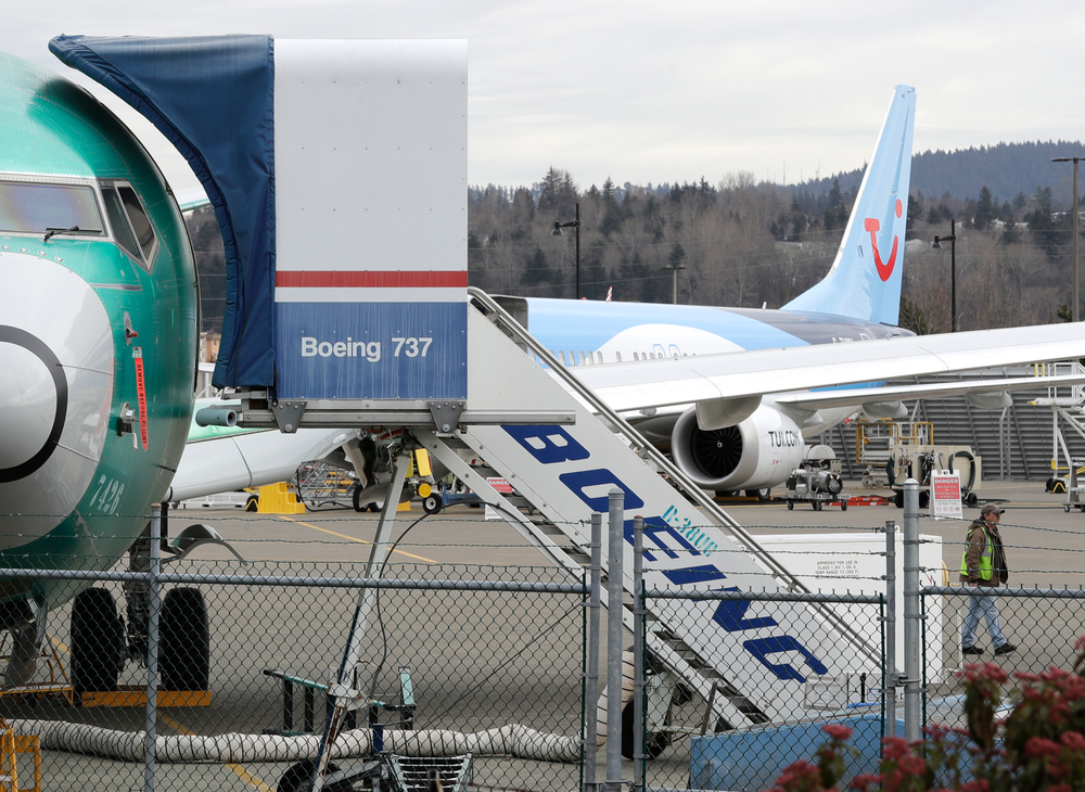 In this photo taken Monday, March 11, 2019, a Boeing 737 MAX 8 airplane being built for TUI Group sits parked in the background at right at Boeing Co.'s Renton Assembly Plant in Renton, Wash. Britain, France and Germany on Tuesday joined a rapidly growing number of countries grounding the new Boeing plane involved in the Ethiopian Airlines disaster or turning it back from their airspace, while investigators in Ethiopia looked for parallels with a similar crash just five months ago. (AP Photo/Ted S. Warren) In this photo taken Monday, March 11, 2019, a Boeing 737 MAX 8 airplane being built for TUI Group sits parked in the background at right at Boeing Co.'s Renton Assembly Plant in Renton, Wash. Britain, France and Germany on Tuesday joined a rapidly growing number of countries grounding the new Boeing plane involved in the Ethiopian Airlines disaster or turning it back from their airspace, while investigators in Ethiopia looked for parallels with a similar crash just five months ago. (AP Photo/Ted S. Warren)
