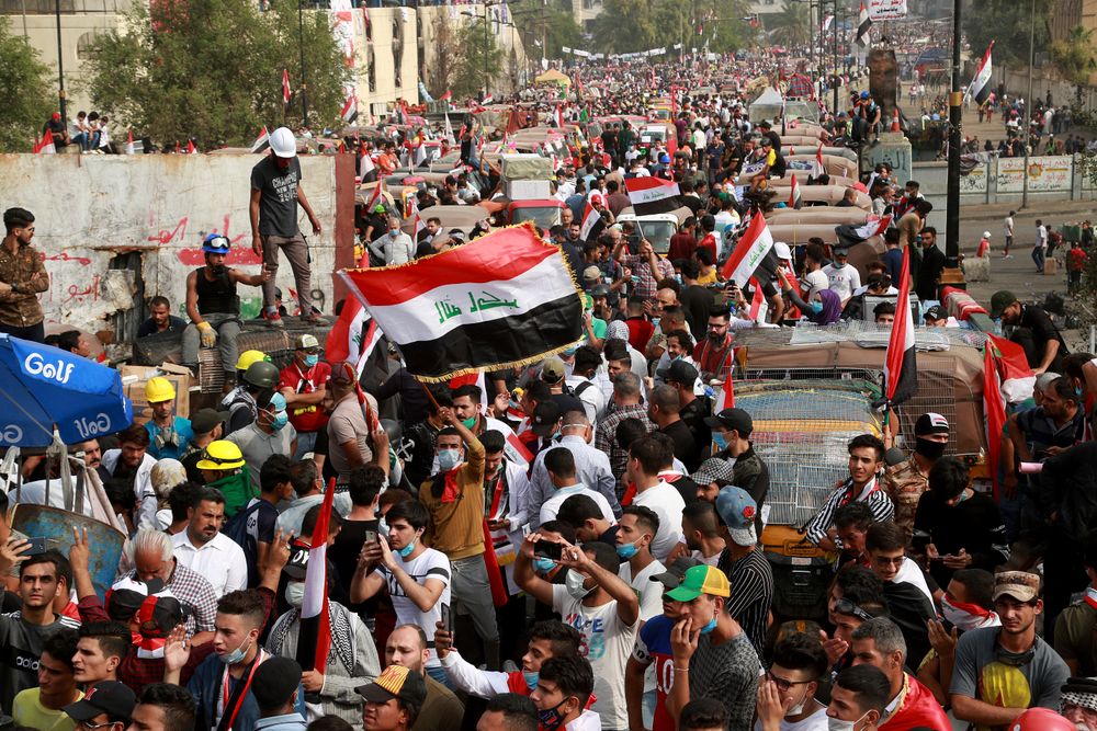 Anti-government protesters march close to the Joumhouriya Bridge that leads to the Green Zone government area, during ongoing protests in Baghdad, Iraq, Sunday, Nov. 3, 2019. (AP Photo/Hadi Mizban) Anti-government protesters march close to the Joumhouriya Bridge that leads to the Green Zone government area, during ongoing protests in Baghdad, Iraq, Sunday, Nov. 3, 2019. (AP Photo/Hadi Mizban)