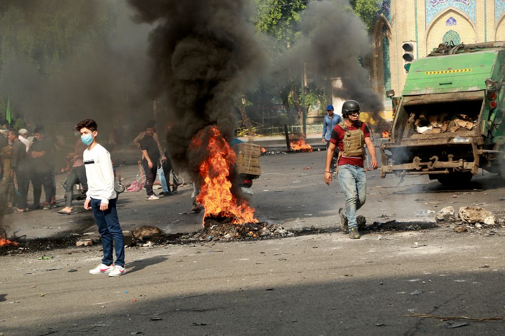 Fires set by protesters close roads during ongoing anti-government protests in Baghdad, Iraq, Sunday, Nov. 3, 2019. Iraqi protesters have begun blocking roads in Baghdad to raise pressure on the government to resign. (AP Photo/Hadi Mizban) Fires set by protesters close roads during ongoing anti-government protests in Baghdad, Iraq, Sunday, Nov. 3, 2019. Iraqi protesters have begun blocking roads in Baghdad to raise pressure on the government to resign. (AP Photo/Hadi Mizban)