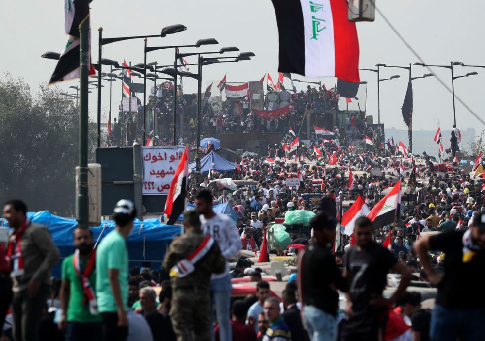 Anti-government protesters stand on barriers set by Iraqi security forces to close the Joumhouriya bridge leading to the Green Zone government areas during ongoing anti-government protests in Baghdad, Iraq, Sunday, Nov. 3, 2019. (AP Photo/Hadi Mizban) Anti-government protesters stand on barriers set by Iraqi security forces to close the Joumhouriya bridge leading to the Green Zone government areas during ongoing anti-government protests in Baghdad, Iraq, Sunday, Nov. 3, 2019. (AP Photo/Hadi Mizban)
