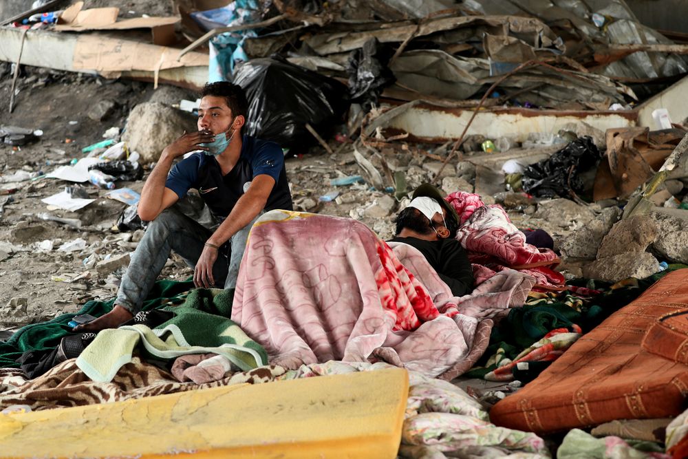 Protesters rest under the Joumhouriya Bridge, that leads to the Green Zone where many government offices and embassies are located, during ongoing anti-government protests, in Baghdad, Iraq, Sunday, Nov. 3, 2019. (AP Photo/Hadi Mizban) Protesters rest under the Joumhouriya Bridge, that leads to the Green Zone where many government offices and embassies are located, during ongoing anti-government protests, in Baghdad, Iraq, Sunday, Nov. 3, 2019. (AP Photo/Hadi Mizban)
