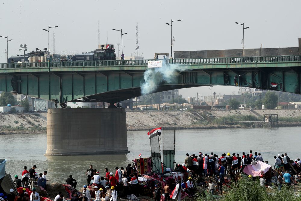 Iraqi security forces use tear gas to disperse anti-government protesters during ongoing protests in Baghdad, Iraq, Sunday, Nov. 3, 2019. (AP Photo/Hadi Mizban) Iraqi security forces use tear gas to disperse anti-government protesters during ongoing protests in Baghdad, Iraq, Sunday, Nov. 3, 2019. (AP Photo/Hadi Mizban)
