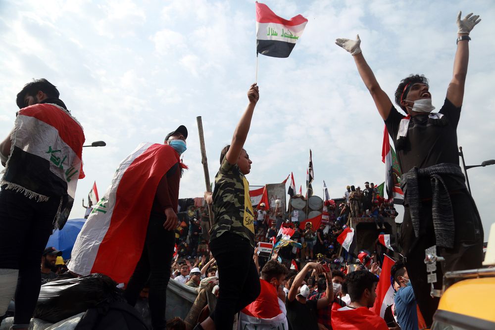 Anti-government protesters stand on barriers set up by Iraqi security forces to close the Joumhouriya Bridge leading to the Green Zone government area, in Baghdad, Iraq, Sunday, Nov. 3, 2019. (AP Photo/Hadi Mizban) Anti-government protesters stand on barriers set up by Iraqi security forces to close the Joumhouriya Bridge leading to the Green Zone government area, in Baghdad, Iraq, Sunday, Nov. 3, 2019. (AP Photo/Hadi Mizban)
