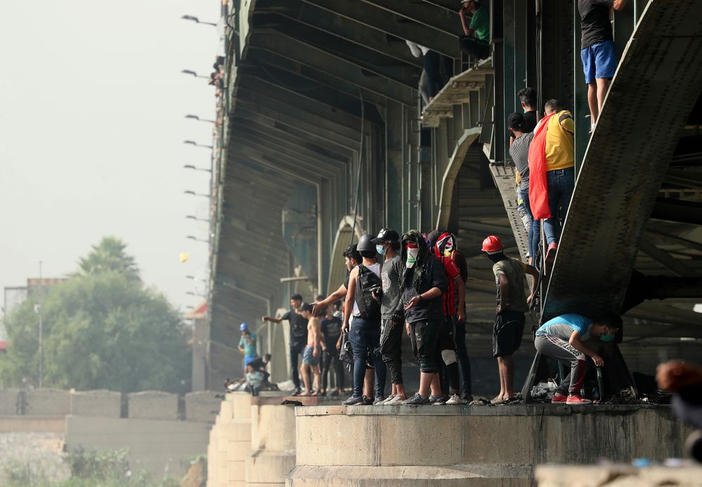 Protesters stand on the Joumhouriya Bridge that leads to the Green Zone government area, during ongoing anti-government protests in Baghdad, Iraq, Sunday, Nov. 3, 2019. (AP Photo/Hadi Mizban) Protesters stand on the Joumhouriya Bridge that leads to the Green Zone government area, during ongoing anti-government protests in Baghdad, Iraq, Sunday, Nov. 3, 2019. (AP Photo/Hadi Mizban)