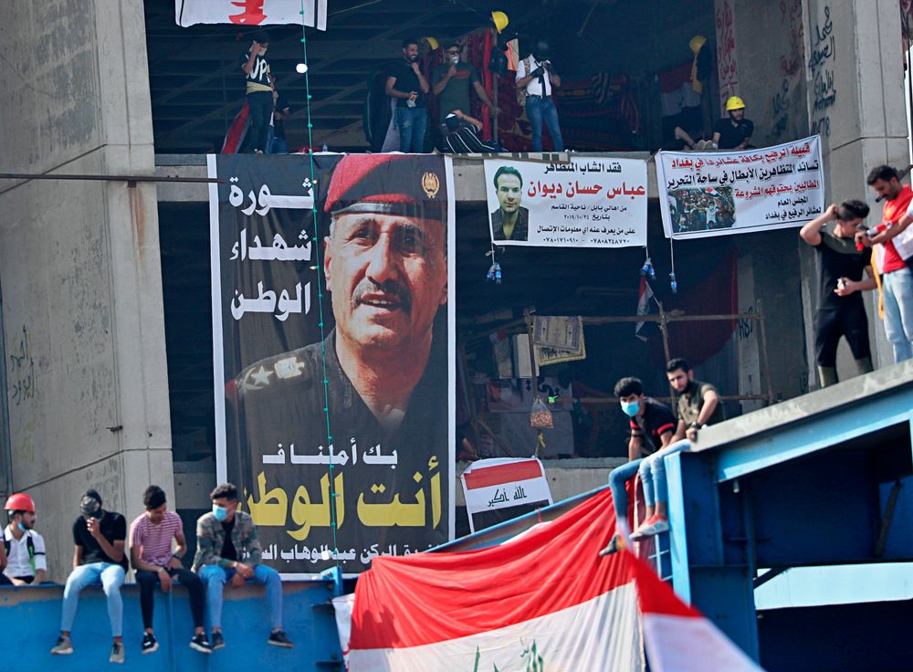 Posters of protesters who have died in anti-government demonstrations and a poster of Lt. Gen. Abdul-Wahab al-Saadi, left, the former commander of the country's elite counterterrorism forces whose dismissal sparked protests about a month ago, hang on a building near Tahrir Square, in Baghdad, Iraq, Sunday, Nov. 3, 2019. (AP Photo/Hadi Mizban) Posters of protesters who have died in anti-government demonstrations and a poster of Lt. Gen. Abdul-Wahab al-Saadi, left, the former commander of the country's elite counterterrorism forces whose dismissal sparked protests about a month ago, hang on a building near Tahrir Square, in Baghdad, Iraq, Sunday, Nov. 3, 2019. (AP Photo/Hadi Mizban)