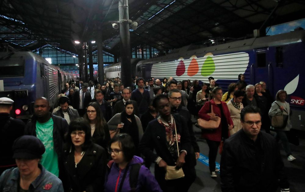Commuters arrive at Gare Saint Lazare train station in Paris, Tuesday, Sept. 24, 2019. A French rail strike is disrupting train travel and unions plan marches in Paris and other cities over President Emmanuel Macron's proposed overhaul of the retirement system. Workers for the SNCF national railway fear the reform will require people to work longer and reduce pensions. (AP Photo/Michel Euler) Commuters arrive at Gare Saint Lazare train station in Paris, Tuesday, Sept. 24, 2019. A French rail strike is disrupting train travel and unions plan marches in Paris and other cities over President Emmanuel Macron's proposed overhaul of the retirement system. Workers for the SNCF national railway fear the reform will require people to work longer and reduce pensions. (AP Photo/Michel Euler)