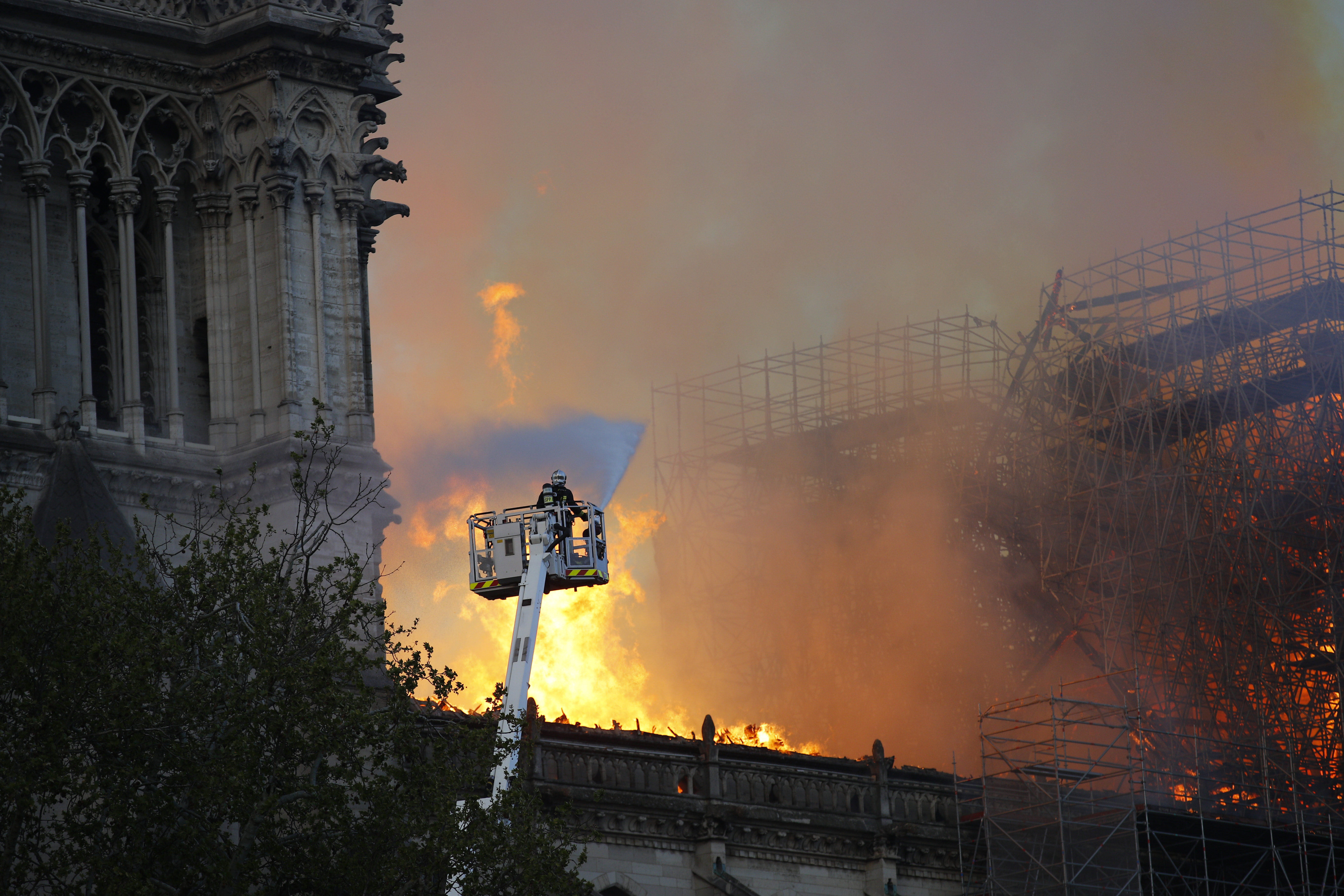 A firefighter uses a hose as Notre Dame cathedral burns in Paris, Monday, April 15, 2019. A catastrophic fire engulfed the upper reaches of Paris' soaring Notre Dame Cathedral as it was undergoing renovations Monday, threatening one of the greatest architectural treasures of the Western world as tourists and Parisians looked on aghast from the streets below. (AP Photo/Francois Mori) A firefighter uses a hose as Notre Dame cathedral burns in Paris, Monday, April 15, 2019. A catastrophic fire engulfed the upper reaches of Paris' soaring Notre Dame Cathedral as it was undergoing renovations Monday, threatening one of the greatest architectural treasures of the Western world as tourists and Parisians looked on aghast from the streets below. (AP Photo/Francois Mori)