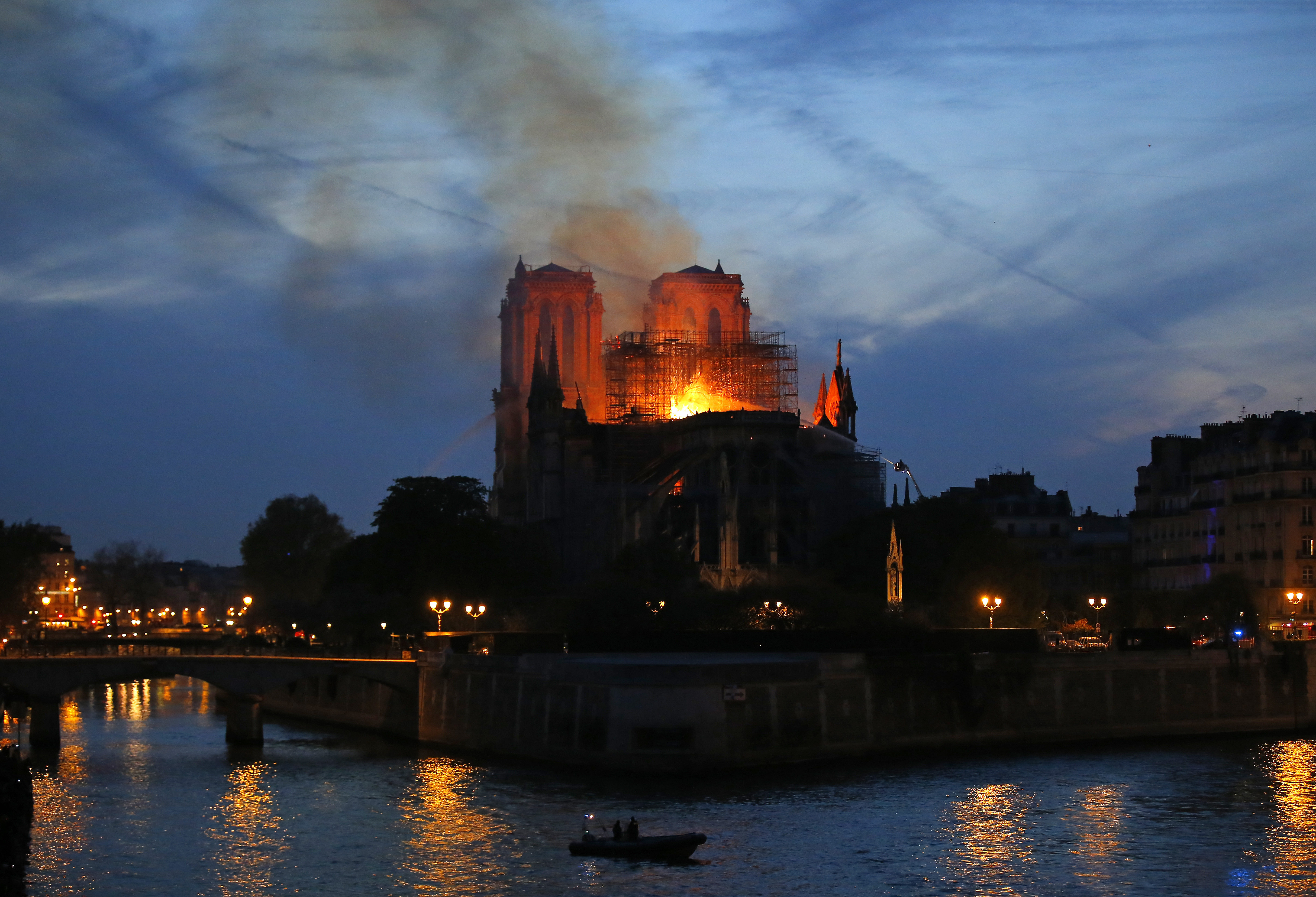 Firefighters tackle the blaze as flames and smoke rise from Notre Dame cathedral as it burns in Paris, Monday, April 15, 2019. Massive plumes of yellow brown smoke is filling the air above Notre Dame Cathedral and ash is falling on tourists and others around the island that marks the center of Paris. (AP Photo/Michel Euler) Firefighters tackle the blaze as flames and smoke rise from Notre Dame cathedral as it burns in Paris, Monday, April 15, 2019. Massive plumes of yellow brown smoke is filling the air above Notre Dame Cathedral and ash is falling on tourists and others around the island that marks the center of Paris. (AP Photo/Michel Euler)