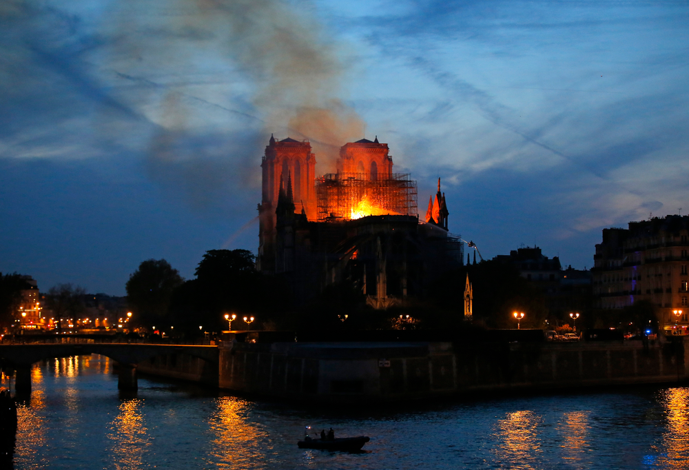 Firefighters tackle the blaze as flames and smoke rise from Notre Dame cathedral as it burns in Paris, Monday, April 15, 2019. Massive plumes of yellow brown smoke is filling the air above Notre Dame Cathedral and ash is falling on tourists and others around the island that marks the center of Paris. (AP Photo/Michel Euler) Firefighters tackle the blaze as flames and smoke rise from Notre Dame cathedral as it burns in Paris, Monday, April 15, 2019. Massive plumes of yellow brown smoke is filling the air above Notre Dame Cathedral and ash is falling on tourists and others around the island that marks the center of Paris. (AP Photo/Michel Euler)