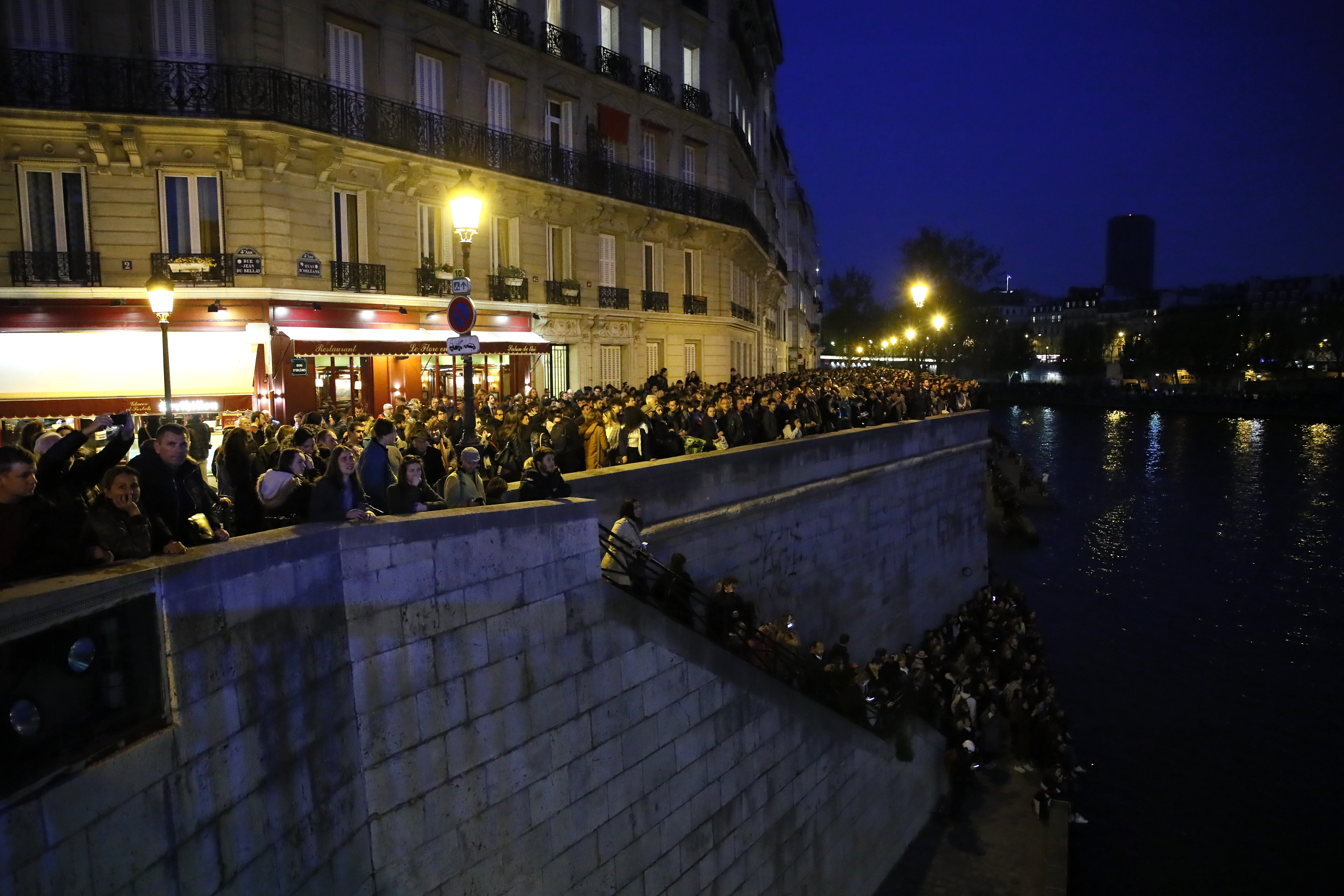 People watch Notre Dame cathedral burning from the Seine river banks in Paris, Monday, April 15, 2019. A catastrophic fire engulfed the upper reaches of Paris' soaring Notre Dame Cathedral as it was undergoing renovations Monday, threatening one of the greatest architectural treasures of the Western world as tourists and Parisians looked on aghast from the streets below. (AP Photo/Francois Mori) People watch Notre Dame cathedral burning from the Seine river banks in Paris, Monday, April 15, 2019. A catastrophic fire engulfed the upper reaches of Paris' soaring Notre Dame Cathedral as it was undergoing renovations Monday, threatening one of the greatest architectural treasures of the Western world as tourists and Parisians looked on aghast from the streets below. (AP Photo/Francois Mori)